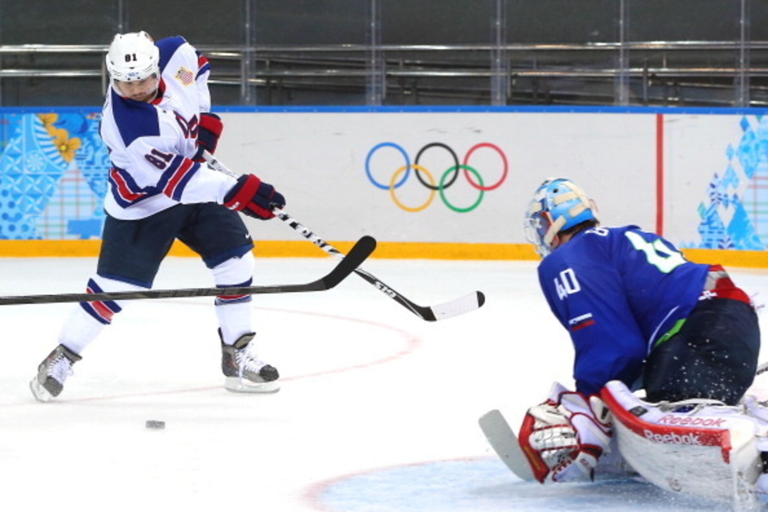 SOCHI, RUSSIA - FEBRUARY 16: Phil Kessel #81 of the United States shoots against Luka Gracnar #40 of Slovenia in the third period during the Men's Ice Hockey Preliminary Round Group A game on day nine of the Sochi 2014 Winter Olympics at Shayba Arena on F
