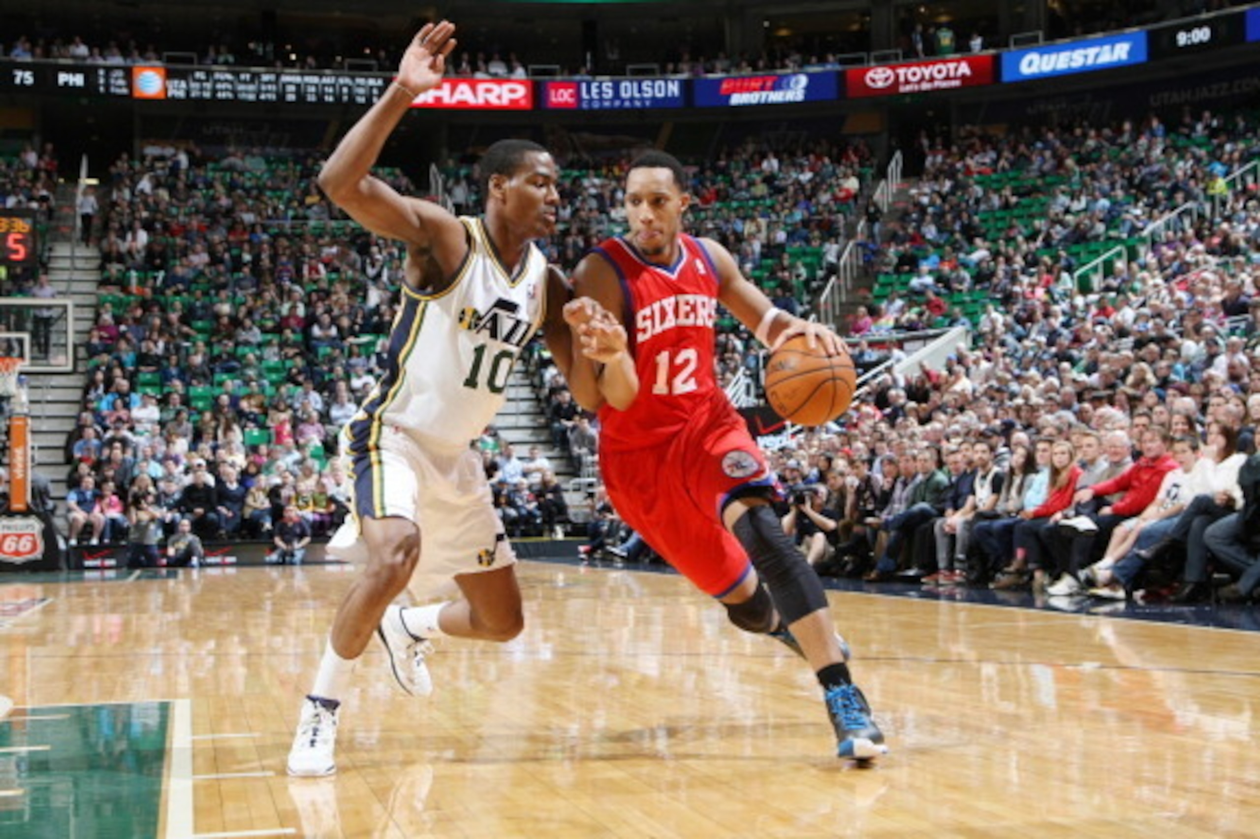 SALT LAKE CITY, UT - FEBRUARY 12:  Evan Turner #12 of the Philadelphia 76ers drives against Alec Burks #10 of the Utah Jazz at EnergySolutions Arena on February 12, 2014 in Salt Lake City, Utah. NOTE TO USER: User expressly acknowledges and agrees that, b