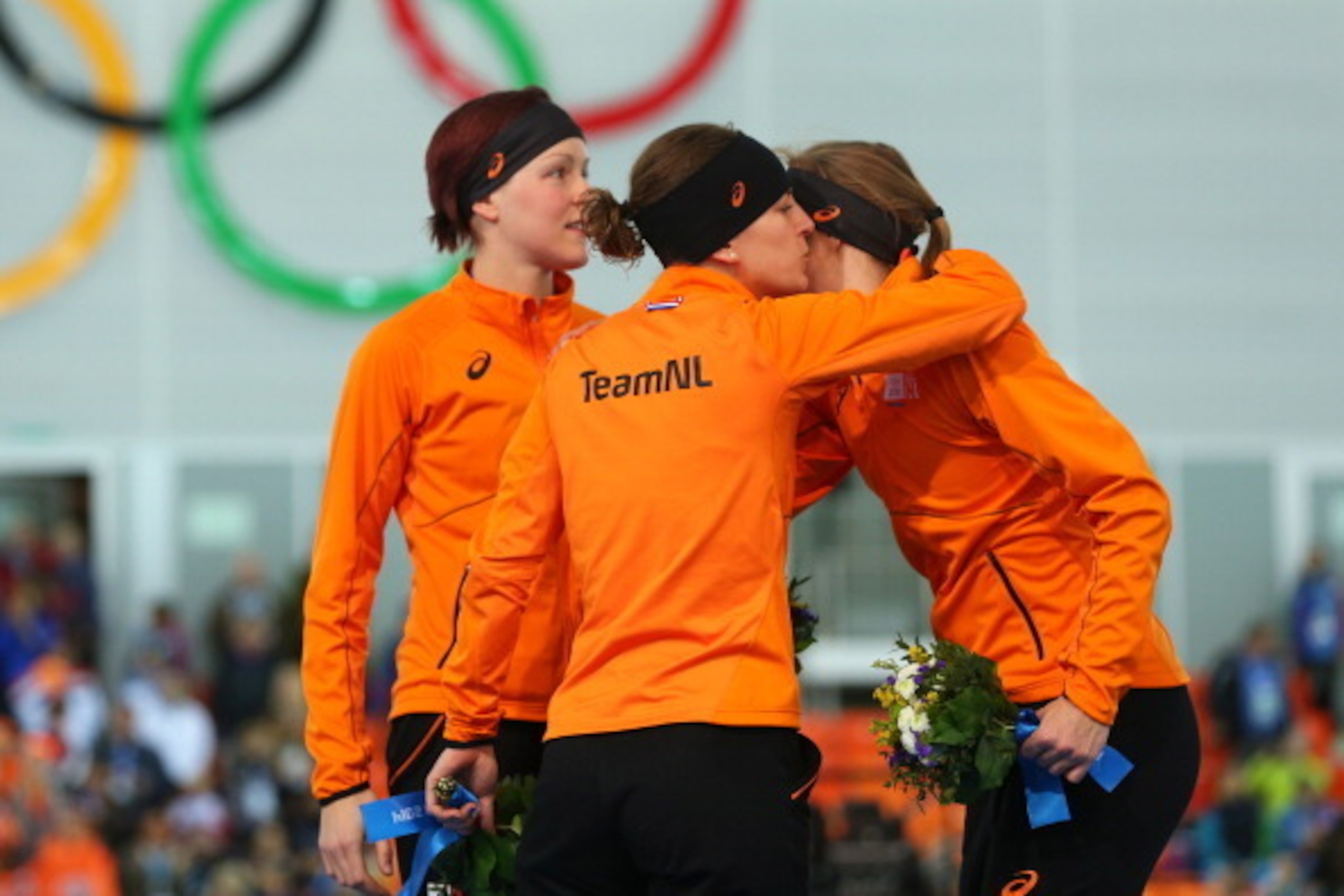 SOCHI, RUSSIA - FEBRUARY 16:  (L-R) Gold medalist Jorien ter Mors of the Netherlands, silver medalist Ireen Wust of the Netherlands and bronze medalist Lotte van Beek of the Netherlands on the podium during the flower ceremony for the Speed Skating Women'