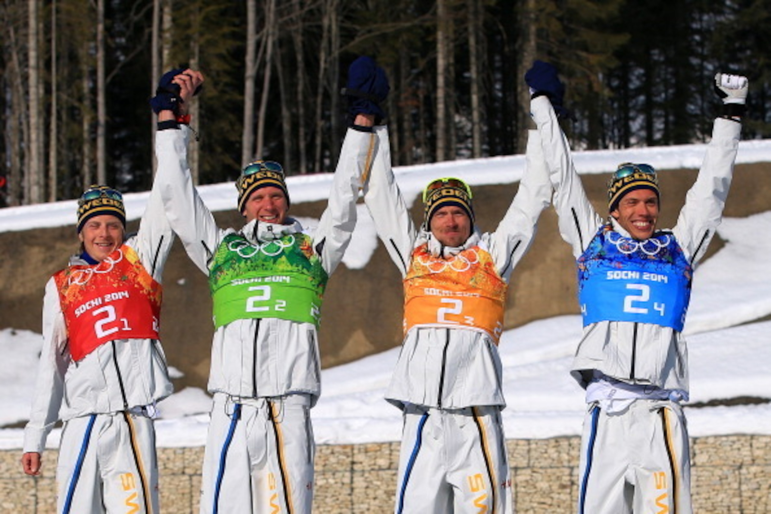 SOCHI, RUSSIA - FEBRUARY 16:  (L to R) Gold medalists Lars Nelson, Daniel Richardsson, Johan Olsson, Marcus Hellner of Sweden celebrate on the podium during the flower ceremony for the Cross Country Men's 4 x 10 km Relay during day nine of the Sochi 2014 