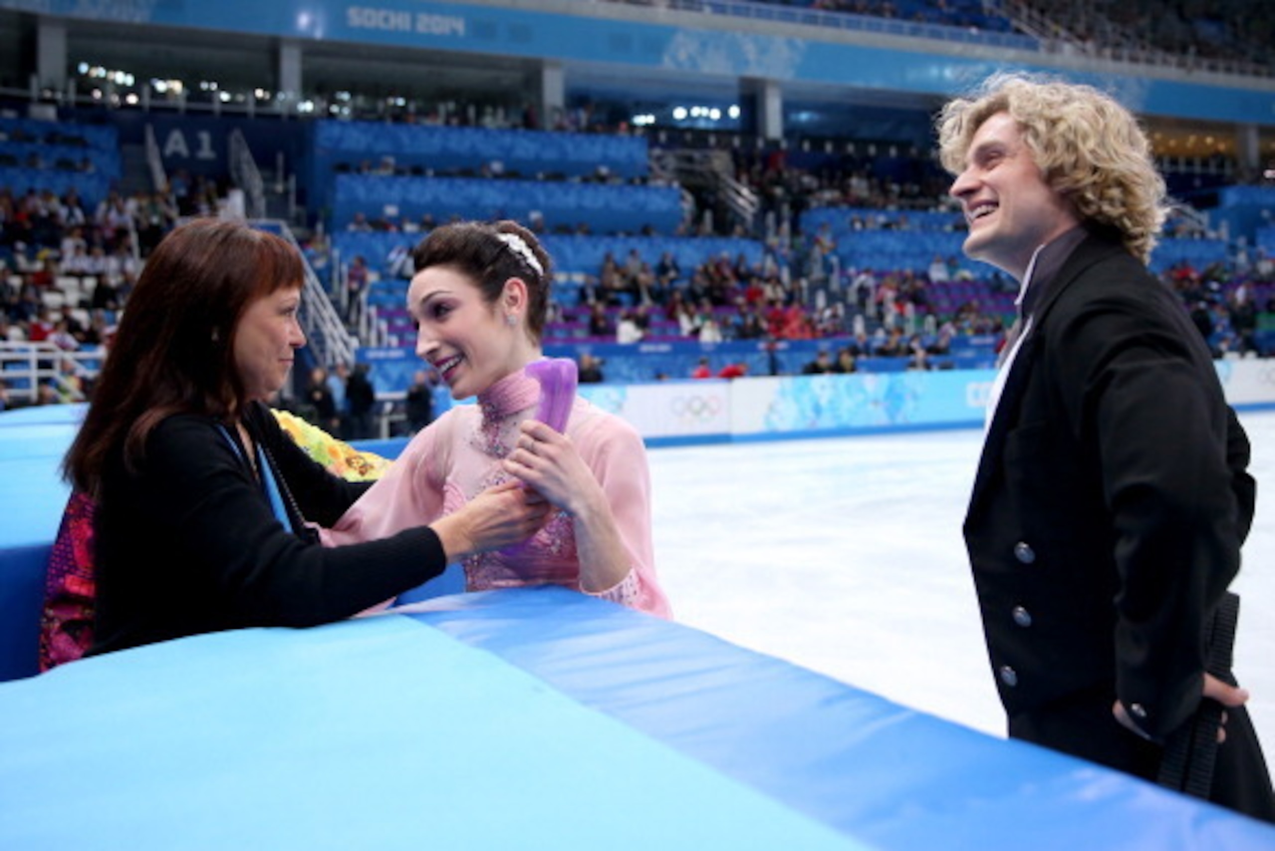 SOCHI, RUSSIA - FEBRUARY 16:  Meryl Davis and Charlie White of the United States si welcomed by their coach Marina Zoueva after competing during the Figure Skating Ice Dance Short Dance on day 9 of the Sochi 2014 Winter Olympics at Iceberg Skating Palace 