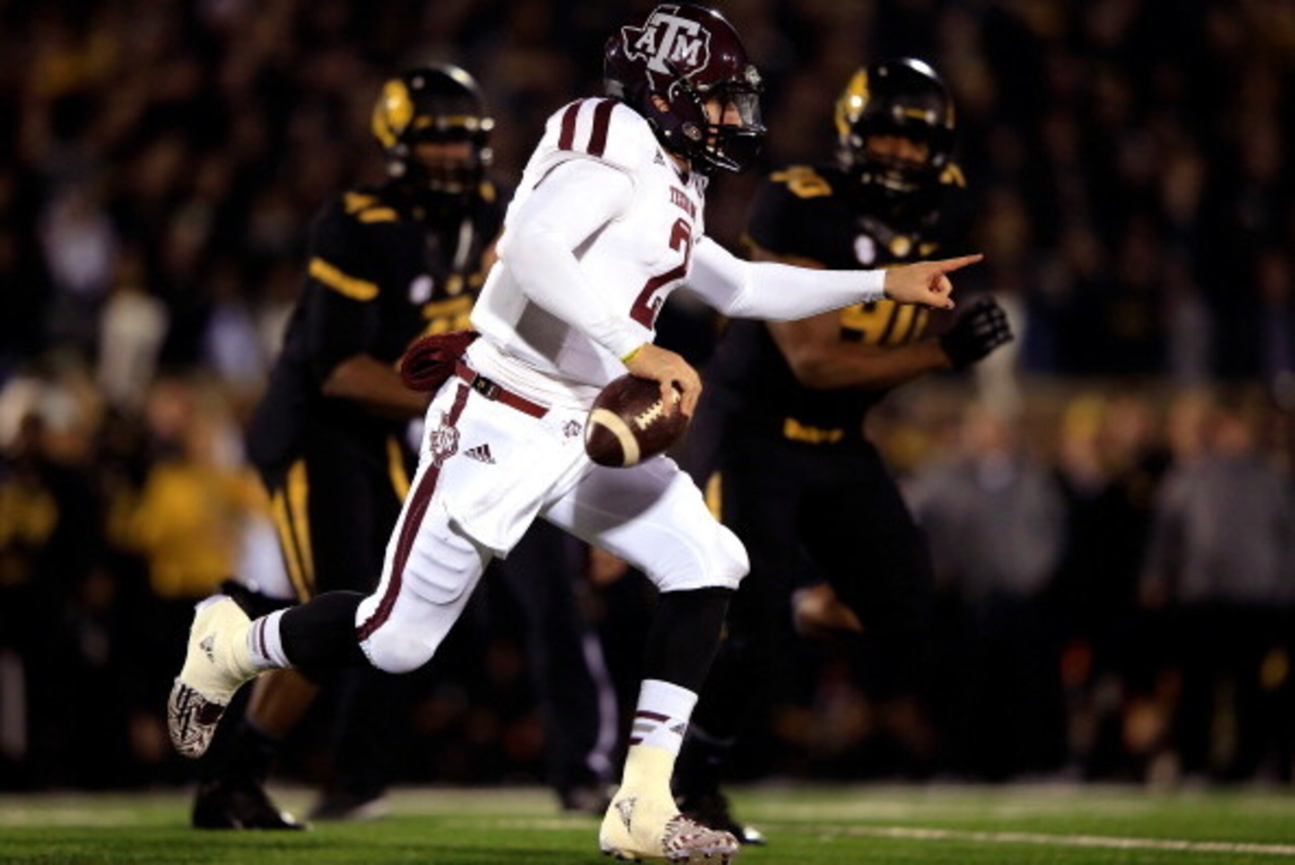 COLUMBIA, MO - NOVEMBER 30:  Quarterback Johnny Manziel #2 of the Texas A&M Aggies scrambles as defensive lineman Harold Brantley #90 of the Missouri Tigers chases during the game on November 30, 2013 in Columbia, Missouri.  (Photo by Jamie Squire/Getty I