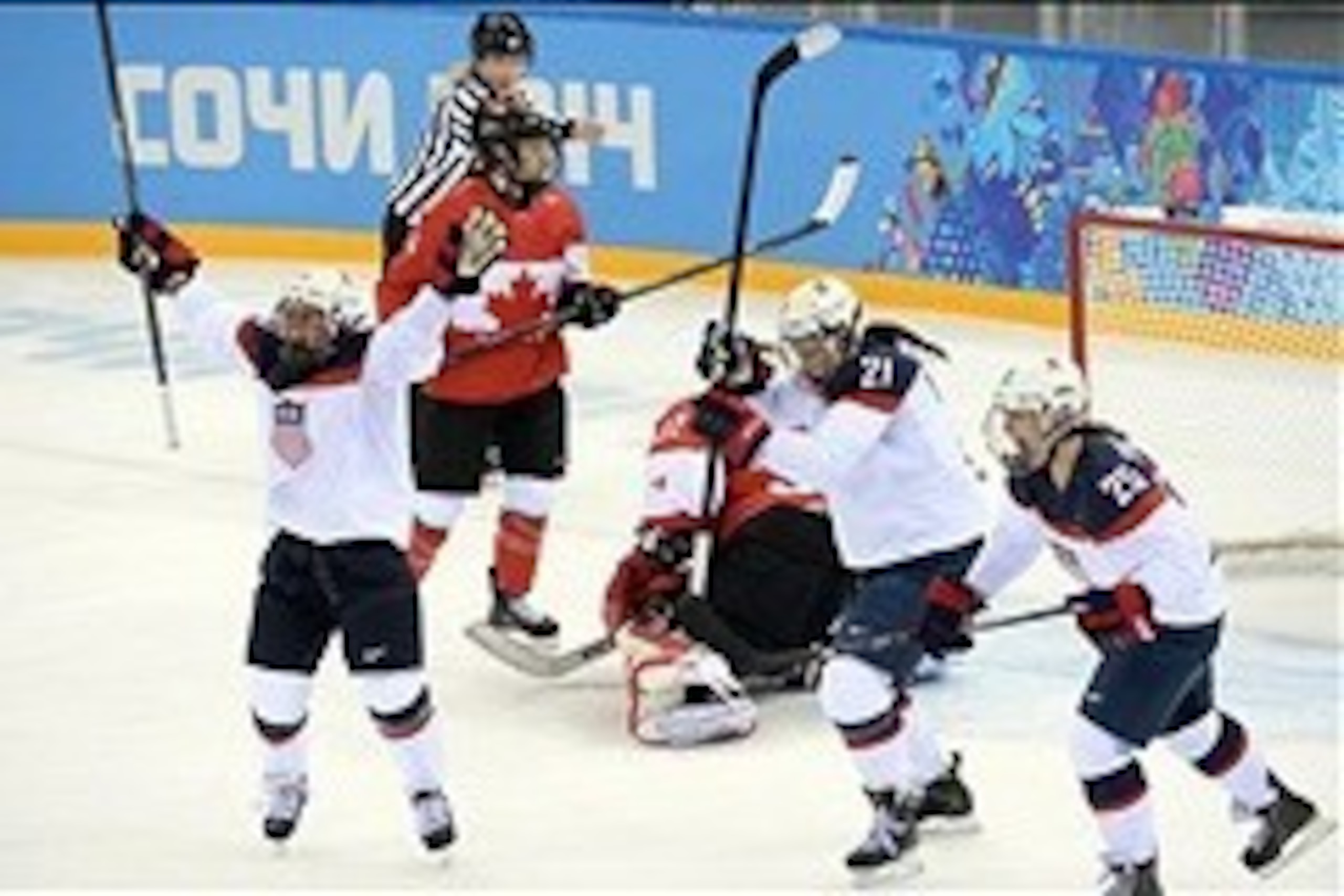 Feb 12, 2014; Sochi, RUSSIA; USA forward Hilary Knight (21) celebrates with teammates forward Alex Carpenter (25) and forward Kelli Stack (16) after a goal against Canada in a women's ice hockey preliminary round game during the Sochi 2014 Olympic Winter 