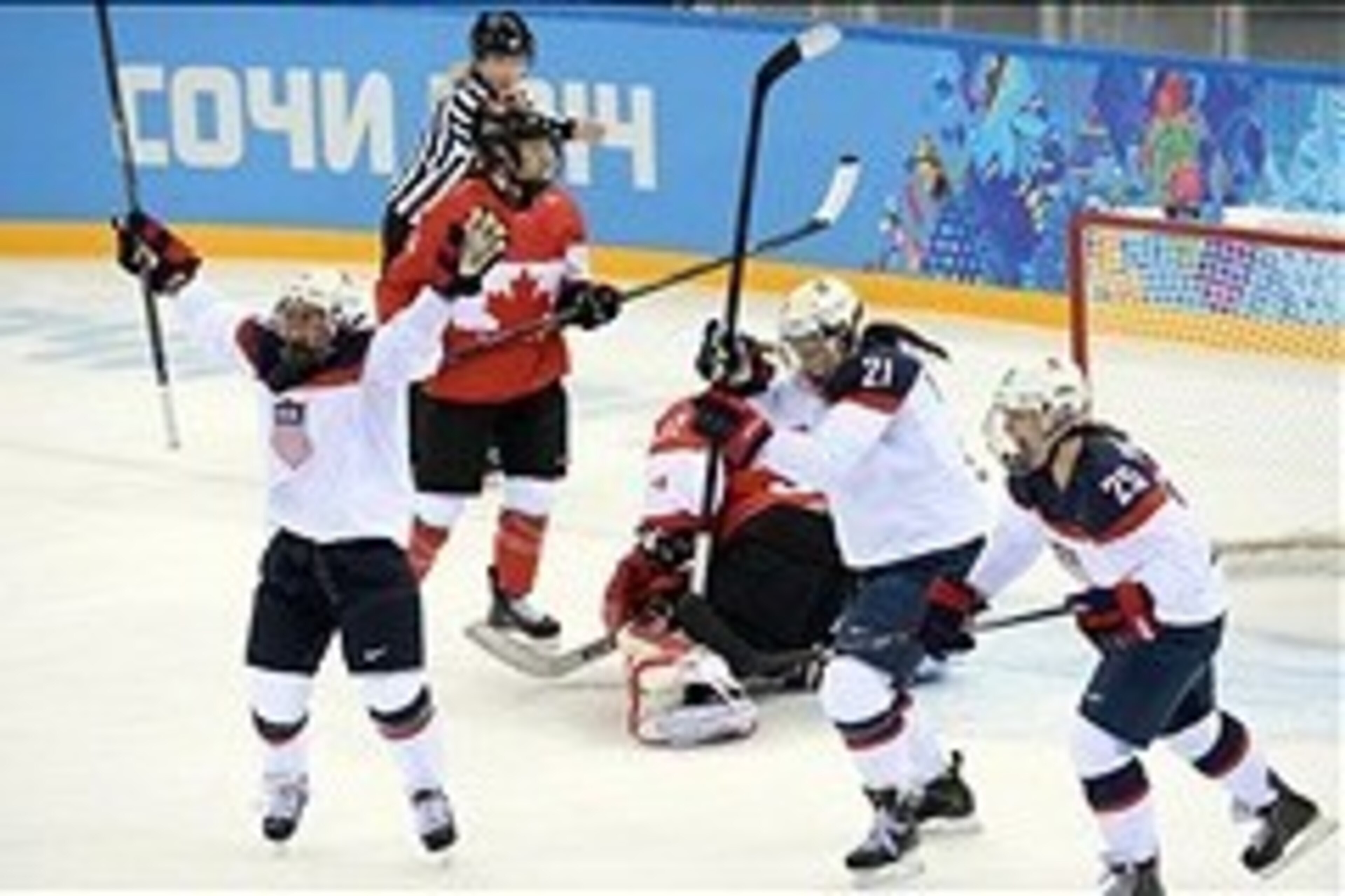 Feb 12, 2014; Sochi, RUSSIA; USA forward Hilary Knight (21) celebrates with teammates forward Alex Carpenter (25) and forward Kelli Stack (16) after a goal against Canada in a women's ice hockey preliminary round game during the Sochi 2014 Olympic Winter 