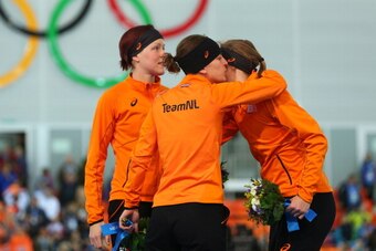 SOCHI, RUSSIA - FEBRUARY 16:  (L-R) Gold medalist Jorien ter Mors of the Netherlands, silver medalist Ireen Wust of the Netherlands and bronze medalist Lotte van Beek of the Netherlands on the podium during the flower ceremony for the Speed Skating Women'