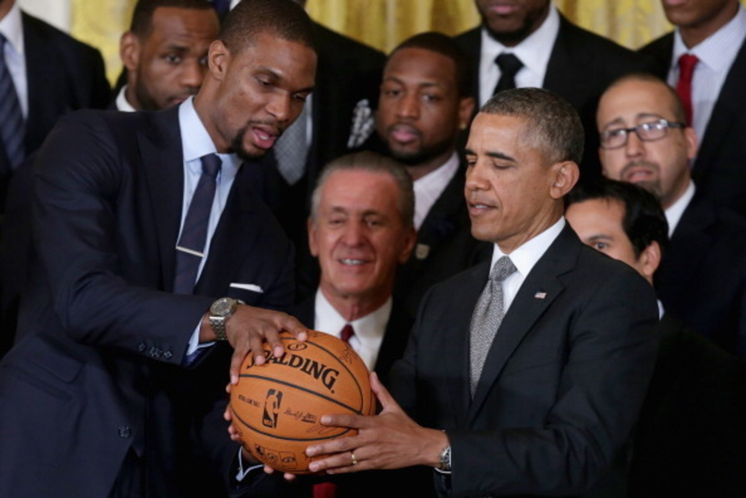 WASHINGTON, DC - JANUARY 14: National Basketball Association 2012-2013 champion Miami Heat player Chris Bosh (L) presents President Barack Obama with a signed basketball during an event at the White House January 14, 2014 in Washington, DC. This is the s WASHINGTON, DC - JANUARY 14: National Basketball Association 2012-2013 champion Miami Heat player Chris Bosh (L) presents President Barack Obama with a signed basketball during an event at the White House January 14, 2014 in Washington, DC. This is the s