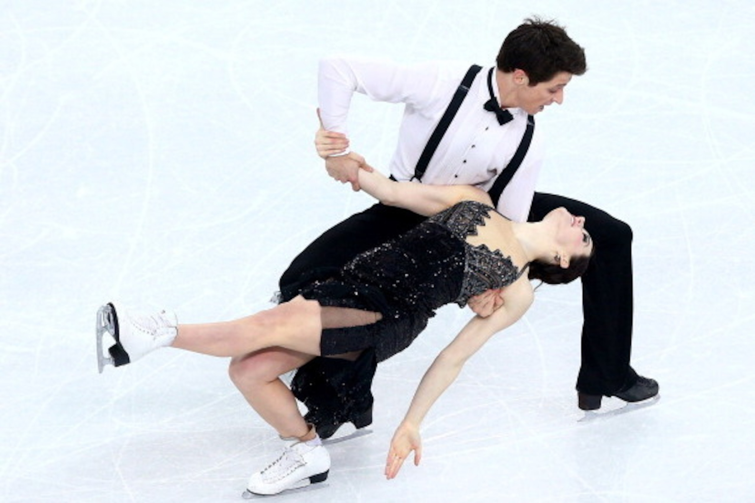 SOCHI, RUSSIA - FEBRUARY 16:  Tessa Virtue and Scott Moir of Canada competes during the Figure Skating Ice Dance Short Dance on day 9 of the Sochi 2014 Winter Olympics at Iceberg Skating Palace on February 16, 2014 in Sochi, Russia.  (Photo by Paul Gilham