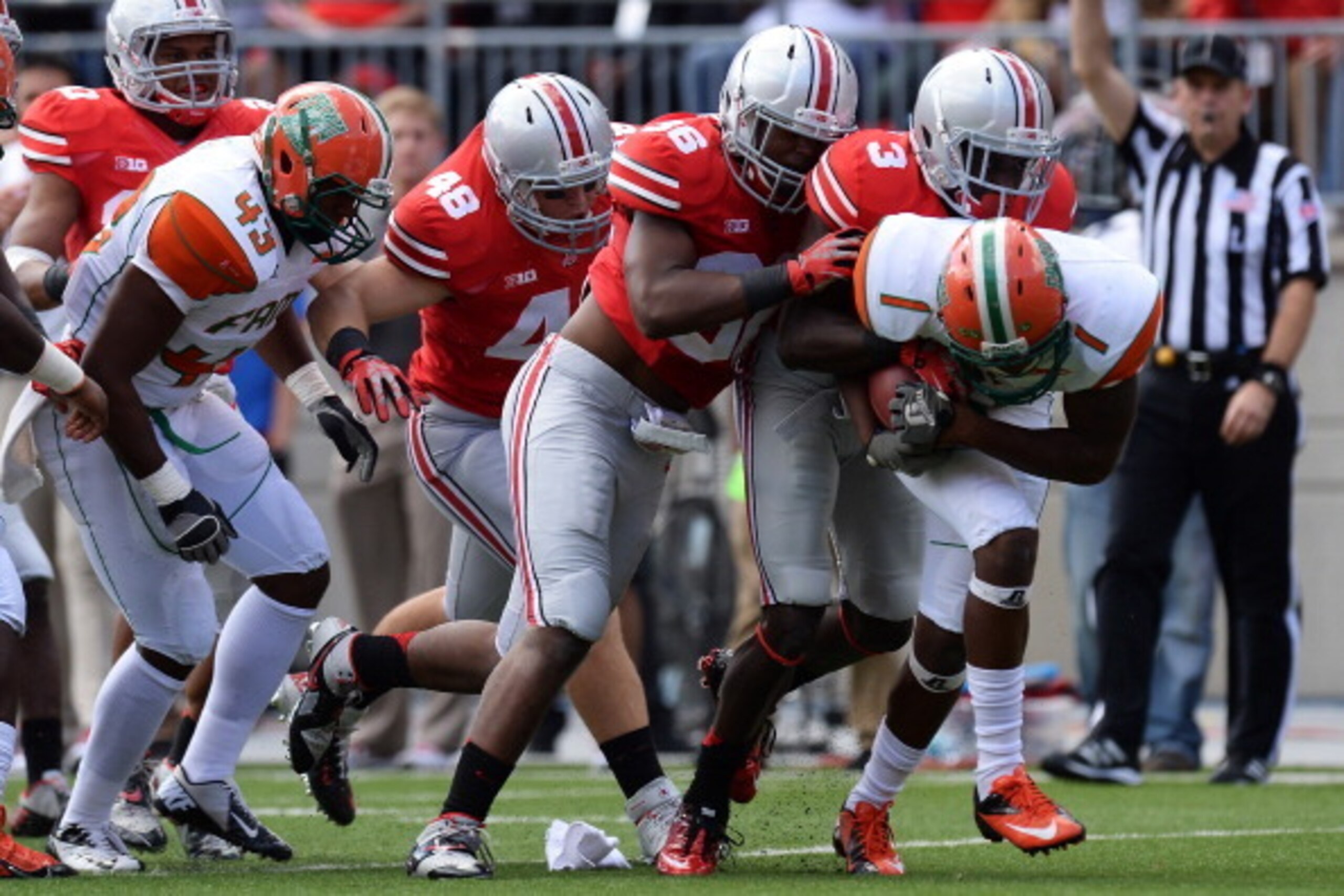 COLUMBUS, OH - SEPTEMBER 21:  Joe Burger #48 of the Ohio State Buckeyes, Trey Johnson #36 of the Ohio State Buckeyes and Corey Brown #3 of the Ohio State Buckeyes gang up to stop ballcarrier Al-Terek McBurse #1 of the Florida A&M Rattlers in the third qua