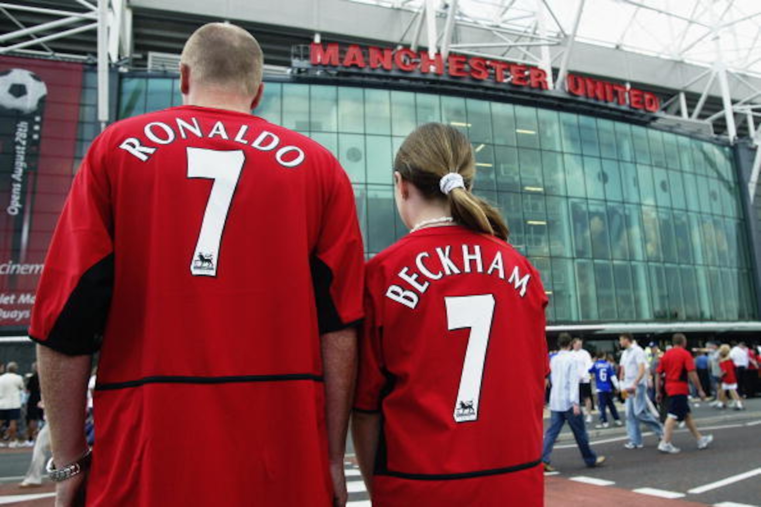 MANCHESTER - AUGUST 16:  Manchester United fans wearing new boy Cristiano Ronaldo and recently departed David Beckham shirts during the FA Barclaycard Premiership match between Manchester United and Bolton Wanderers held on August 16, 2003 at Old Trafford