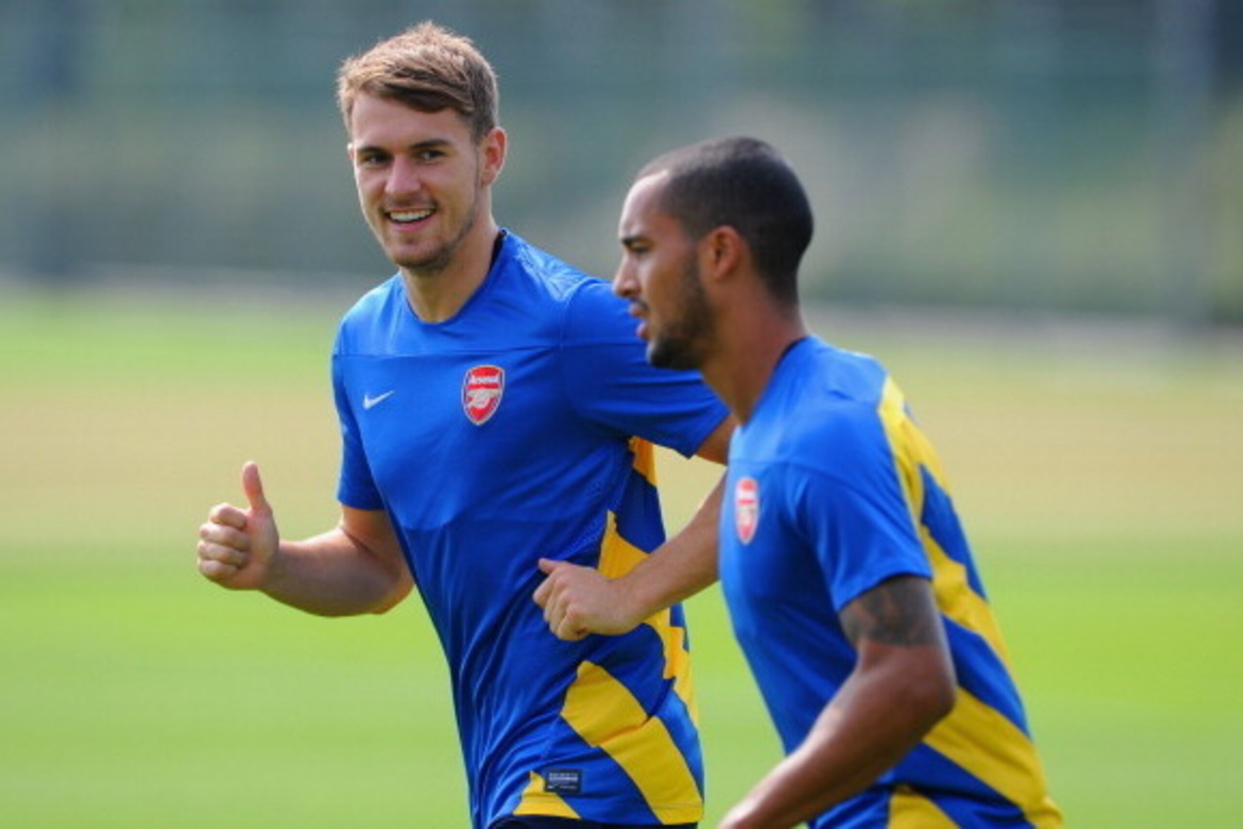 ST ALBANS, ENGLAND - AUGUST 26: Aaron Ramsey and Theo Walcott of Arsenal warm up during a training session ahead of their UEFA Champions League Play Off second leg match against Fenerbache at London Colney on August 26, 2013 in St Albans, England.  (Photo