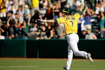 OAKLAND, CA - JUNE 13:  Nate Freiman #7 of the Oakland Athletics celebrates as he runs up the first base line after he hit a single that scored John Jaso #5 in the bottom of the 18th inning to beat the New York Yankees at O.co Coliseum on June 13, 2013 in
