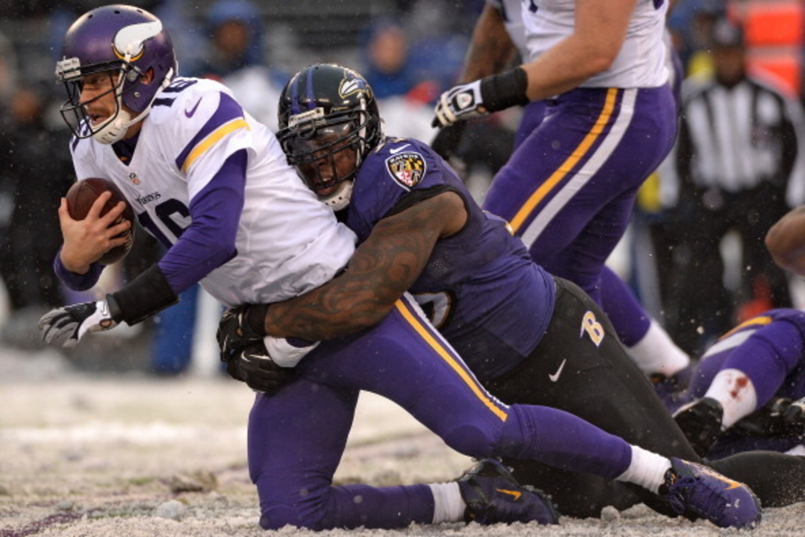 BALTIMORE, MD - DECEMBER 08: Quarterback Matt Cassel #16 of the Minnesota Vikings is tackled by outside linebacker Terrell Suggs #55 of the Baltimore Ravens in the third quarter at M&T Bank Stadium on December 8, 2013 in Baltimore, Maryland. The Baltimore