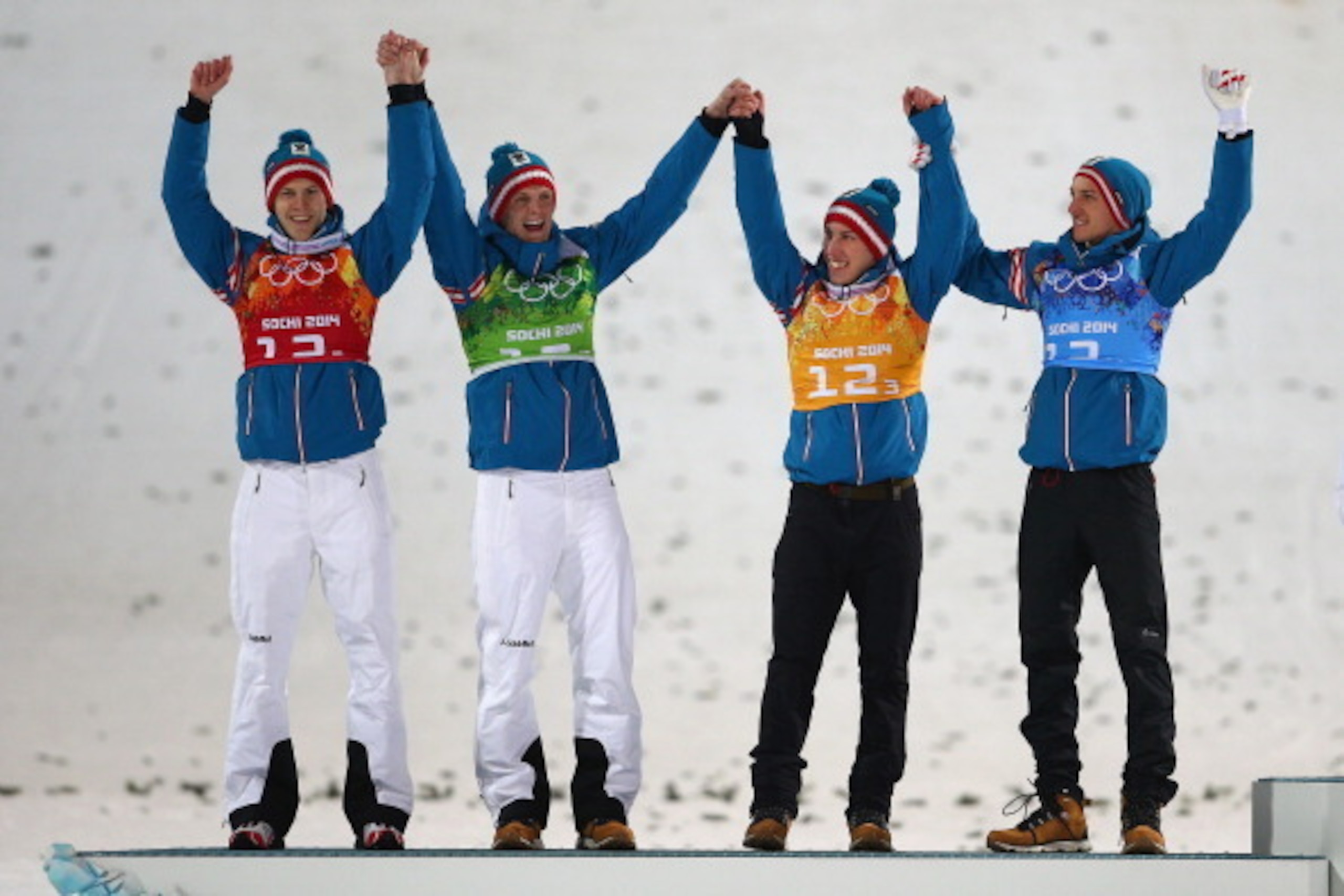SOCHI, RUSSIA - FEBRUARY 17: (L-R) Silver medalists Michael Hayboeck, Thomas Morgenstern, Thomas Diethart and Gregor Schlierenzauer of Austria celebrate during the flower ceremony for the Men's Team Ski Jumping final round on day 10 of the Sochi 2014 Wint