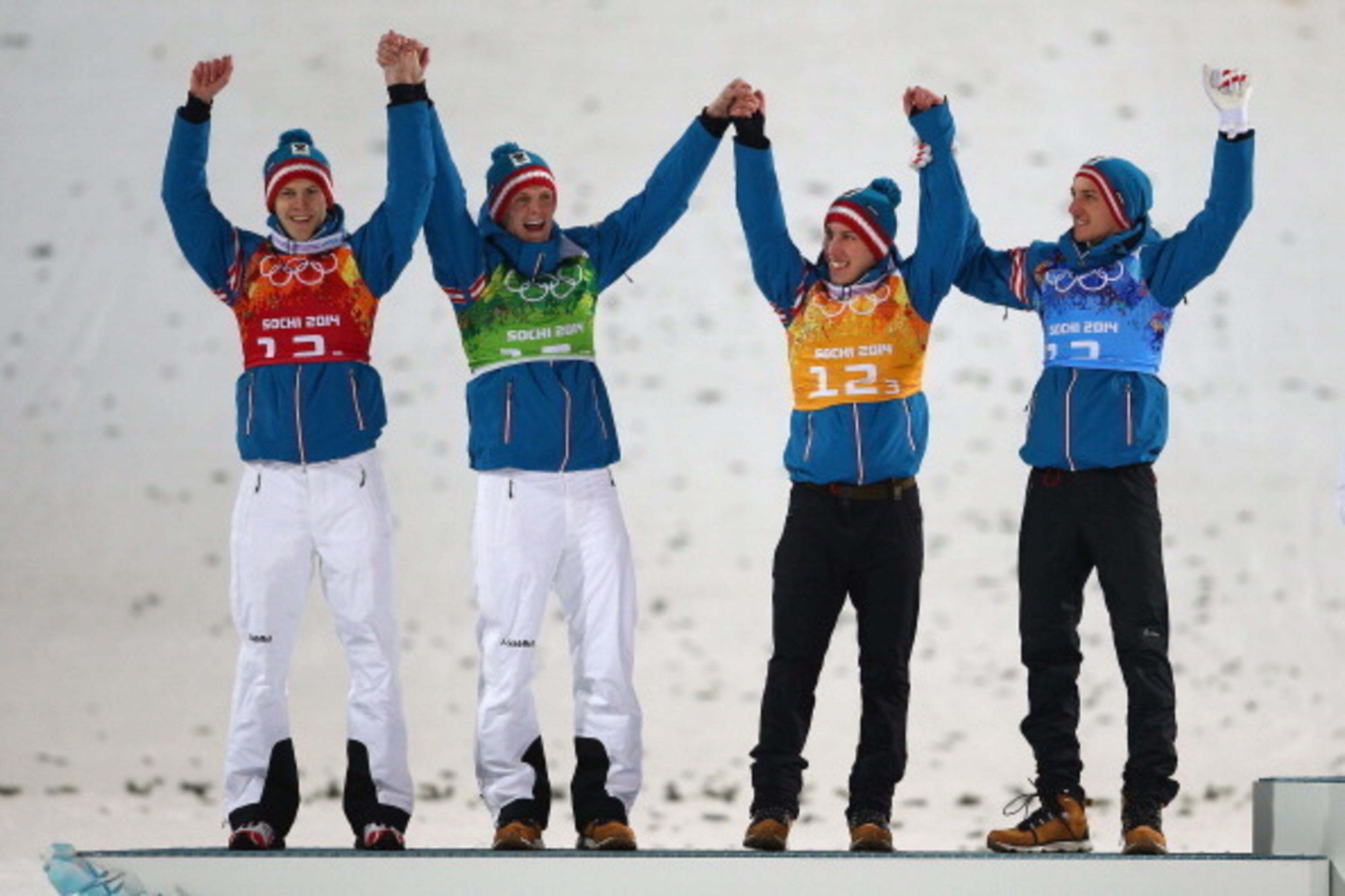 SOCHI, RUSSIA - FEBRUARY 17: (L-R) Silver medalists Michael Hayboeck, Thomas Morgenstern, Thomas Diethart and Gregor Schlierenzauer of Austria celebrate during the flower ceremony for the Men's Team Ski Jumping final round on day 10 of the Sochi 2014 Wint