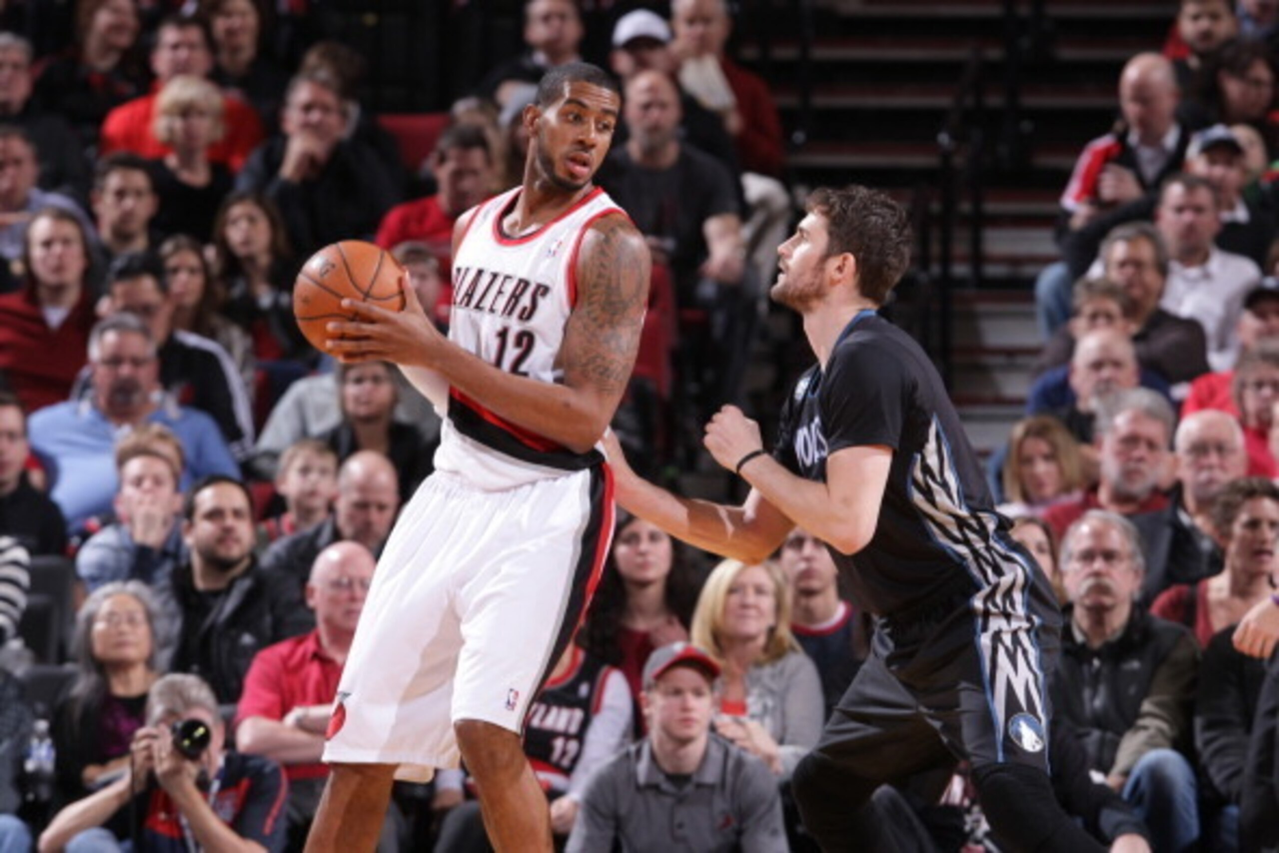 PORTLAND, OR - JANUARY 25:  LaMarcus Aldridge #12 of the Portland Trail Blazers backs down Kevin Love #42 of the Minnesota Timberwolves on January 25, 2014 at the Moda Center Arena in Portland, Oregon. NOTE TO USER: User expressly acknowledges and agrees 