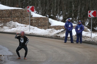 SOCHI, RUSSIA - FEBRUARY 10:  Kate Hansen of the United States dances as she listens to music watched by security prior to the Women's Luge Singles on Day 3 of the Sochi 2014 Winter Olympics at Sliding Center Sanki on February 10, 2014 in Sochi, Russia.  