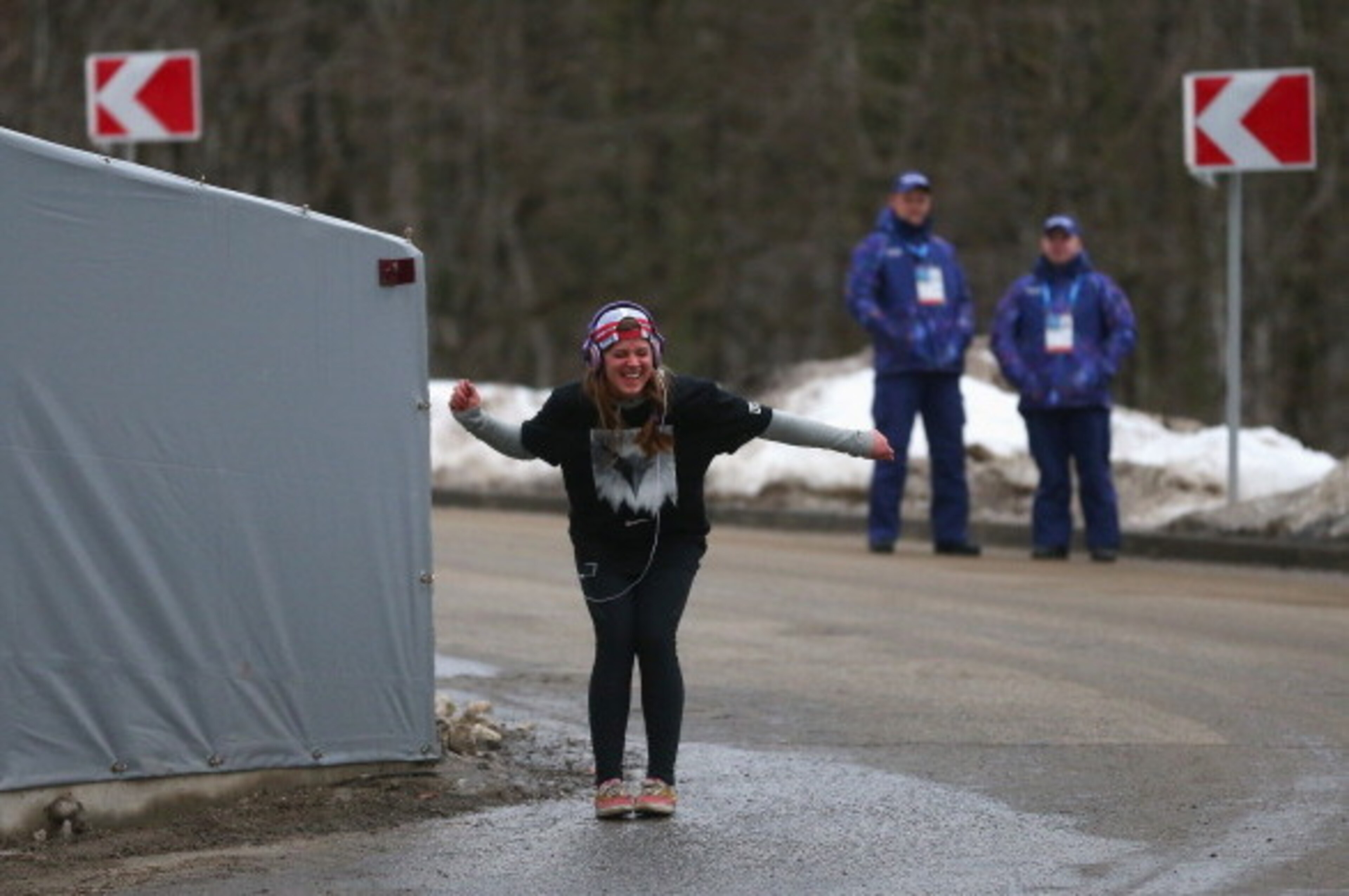 SOCHI, RUSSIA - FEBRUARY 10:  Kate Hansen of the United States dances as she listens to music watched by security prior to the Women's Luge Singles on Day 3 of the Sochi 2014 Winter Olympics at Sliding Center Sanki on February 10, 2014 in Sochi, Russia.  