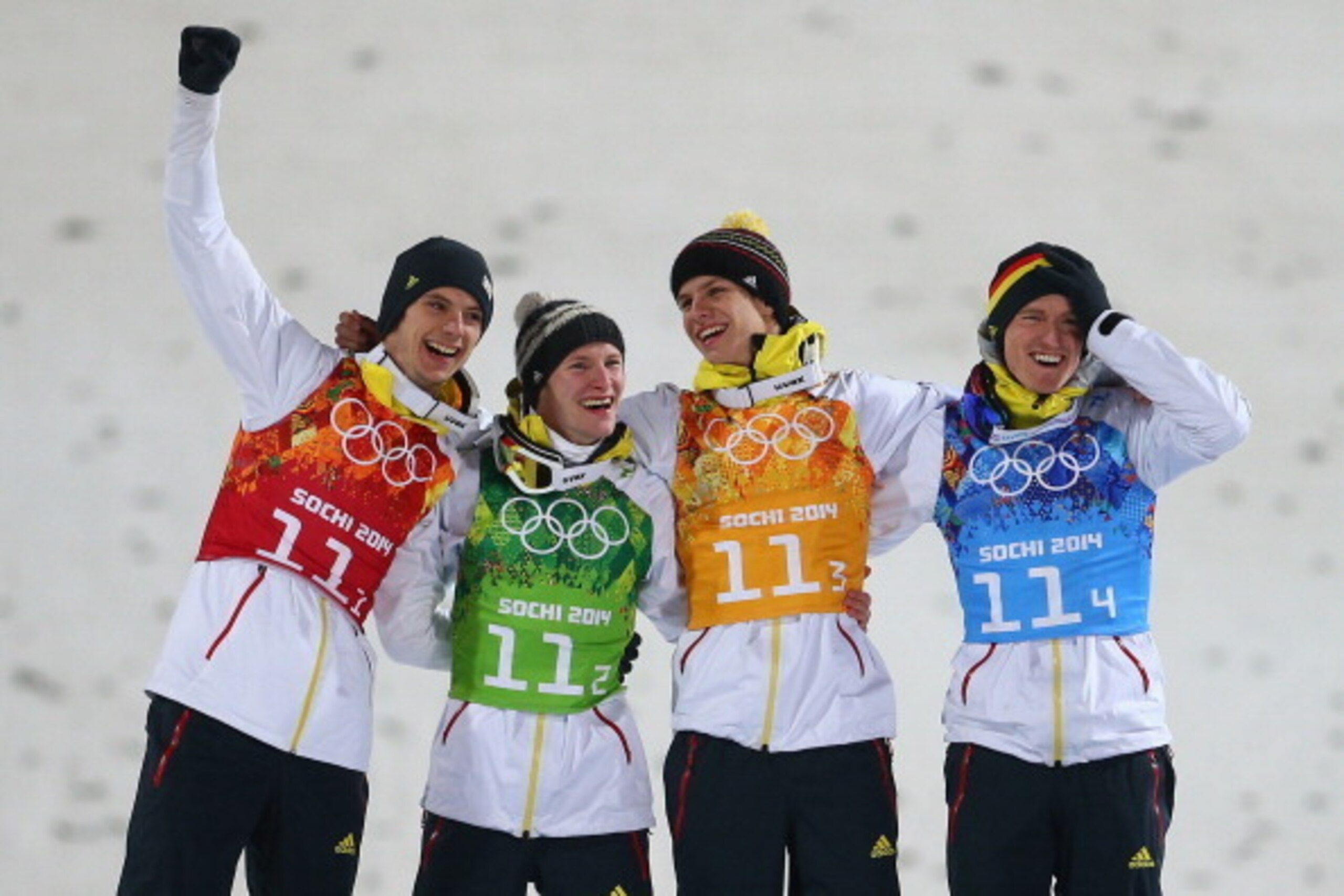 SOCHI, RUSSIA - FEBRUARY 17:  (L-R) Gold medalists Andreas Wank, Marinus Kraus, Andreas Wellinger and Severin Freund of Germany celebrate during the flower ceremony for the  Men's Team Ski Jumping final round on day 10 of the Sochi 2014 Winter Olympics at
