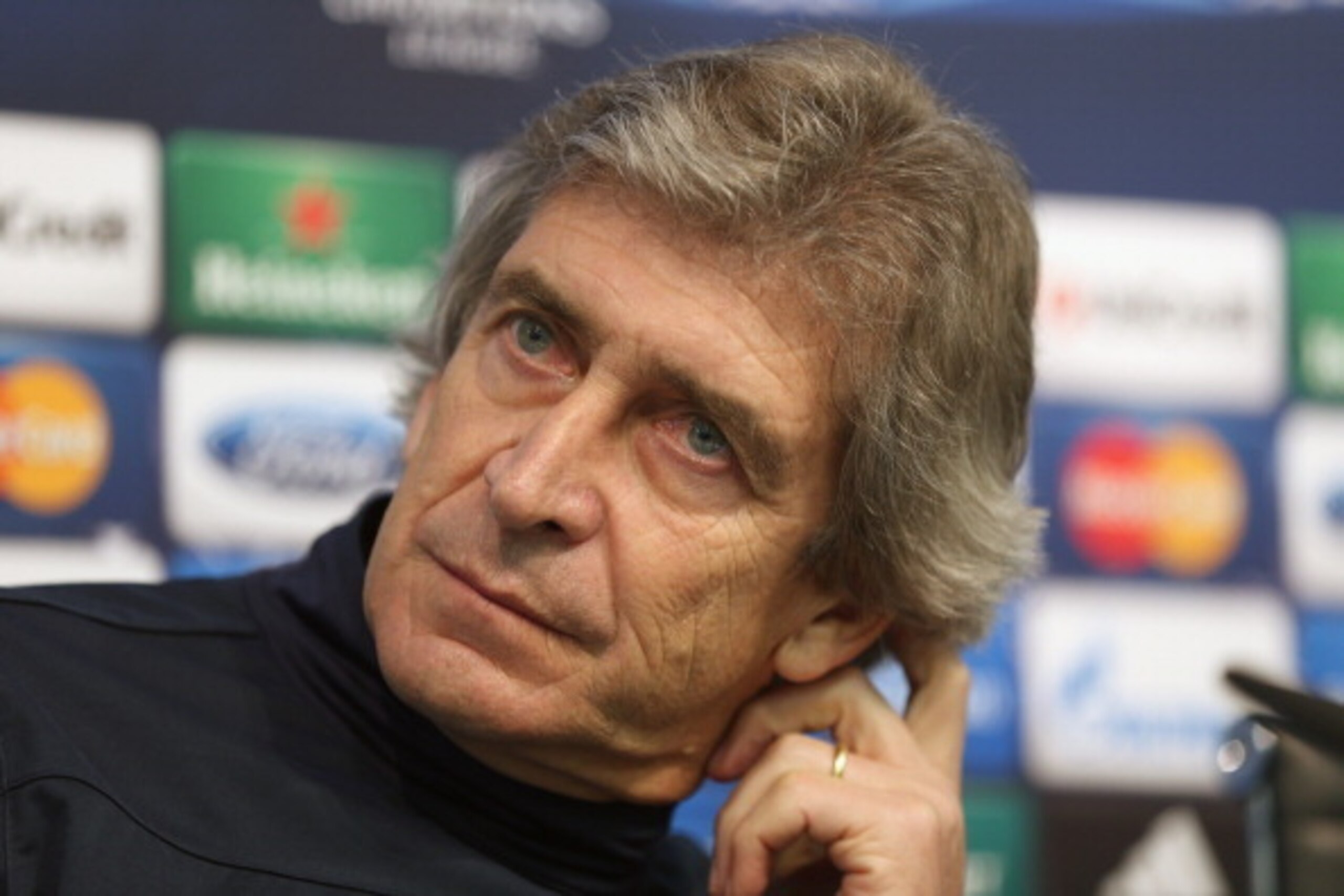MANCHESTER, ENGLAND - FEBRUARY 17:  Manchester City manager Manuel Pellegrini listens to questions from the media during a press conference after a training session ahead of their UEFA Champions League Round of 16 match 1st leg against Barcelona  at Etiha