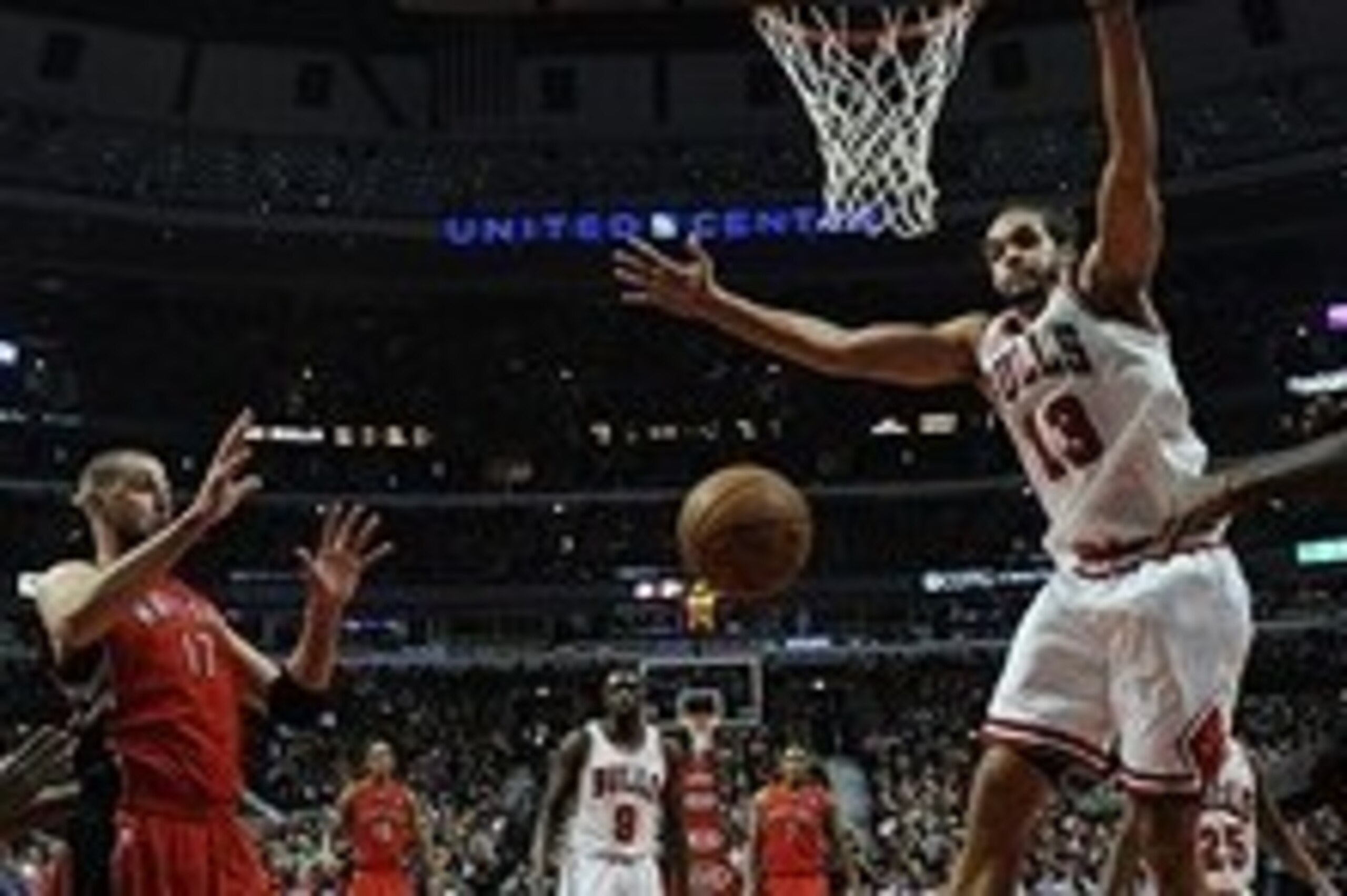 Dec 14, 2013; Chicago, IL, USA; Chicago Bulls center Joakim Noah (13) tries to block a pass to Toronto Raptors center Jonas Valanciunas (17) during the first quarter at the  United Center. Mandatory Credit: David Banks-USA TODAY Sports