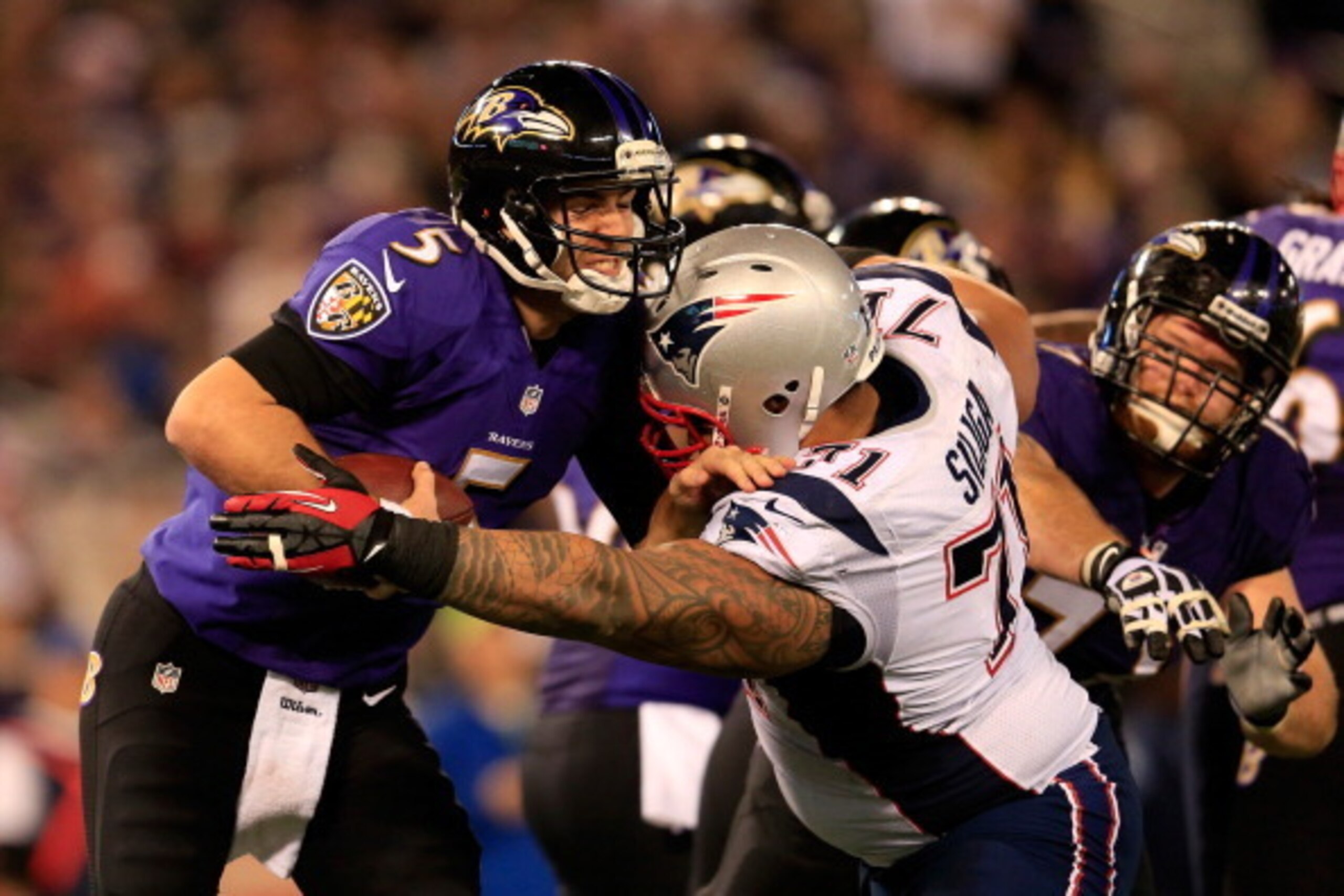 BALTIMORE, MD - DECEMBER 22: Defensive tackle Sealver Siliga #71 of the New England Patriots sacks quarterback Joe Flacco #5 of the Baltimore Ravens during the second half of the Patriots 41-7 win at M&T Bank Stadium on December 22, 2013 in Baltimore, Mar