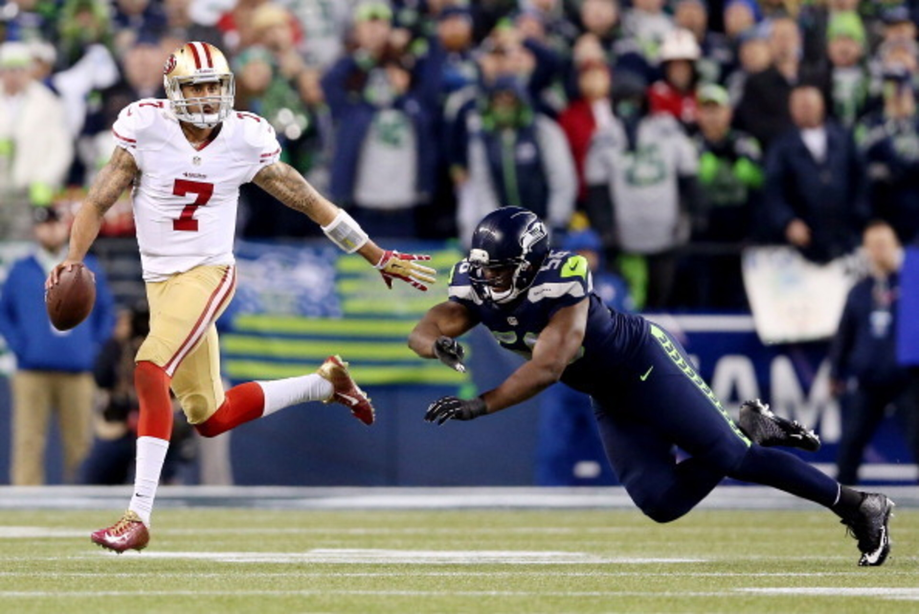 SEATTLE, WA - JANUARY 19: Quarterback Colin Kaepernick #7 of the San Francisco 49ers runs with the ball as defensive end Cliff Avril #56 of the Seattle Seahawks tries to make the tackle during the 2014 NFC Championship at CenturyLink Field on January 19, SEATTLE, WA - JANUARY 19: Quarterback Colin Kaepernick #7 of the San Francisco 49ers runs with the ball as defensive end Cliff Avril #56 of the Seattle Seahawks tries to make the tackle during the 2014 NFC Championship at CenturyLink Field on January 19,