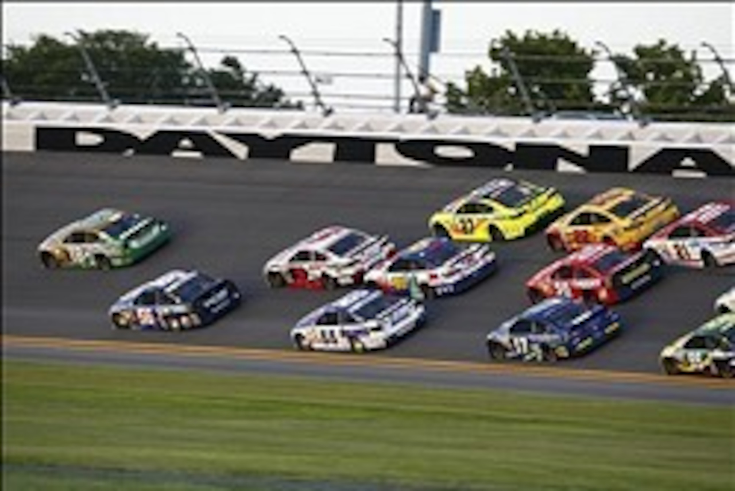 Jul 6, 2013; Daytona Beach, FL, USA; NASCAR Sprint Cup Series driver Kyle Busch (18) leads the field into turn three during the Coke Zero 400 at Daytona International Speedway. Mandatory Credit: Douglas Jones-USA TODAY Sports