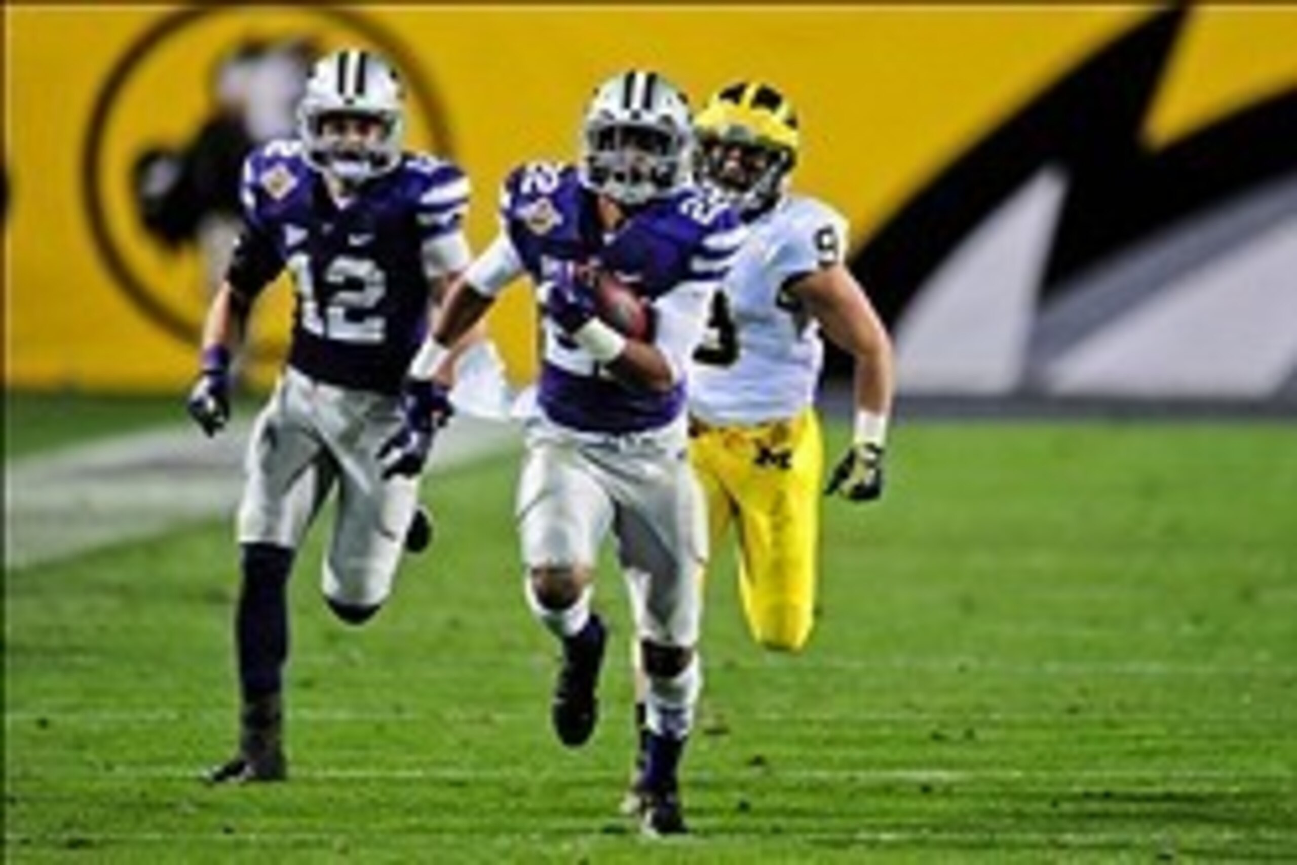 Dec 28, 2013; Tempe, AZ, USA; Kansas State Wildcats defensive back Carl Miles Jr. (2) returns an interception 51 yards as defensive back Ty Zimmerman (12) blocks and Michigan Wolverines wide receiver Drew Dileo (9) defends during the second half in the Bu