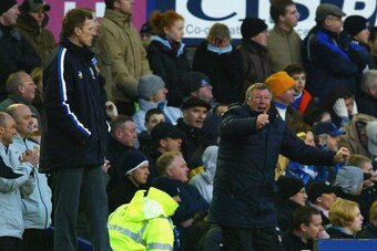 LIVERPOOL, ENGLAND - FEBRUARY 7:  Manchester United Manager Alex Ferguson celebrates the winning goal as Everton Manager David Moyes looks on during the FA Barclaycard Premiership match between Everton and Manchester United at Goodison Park on February 7,