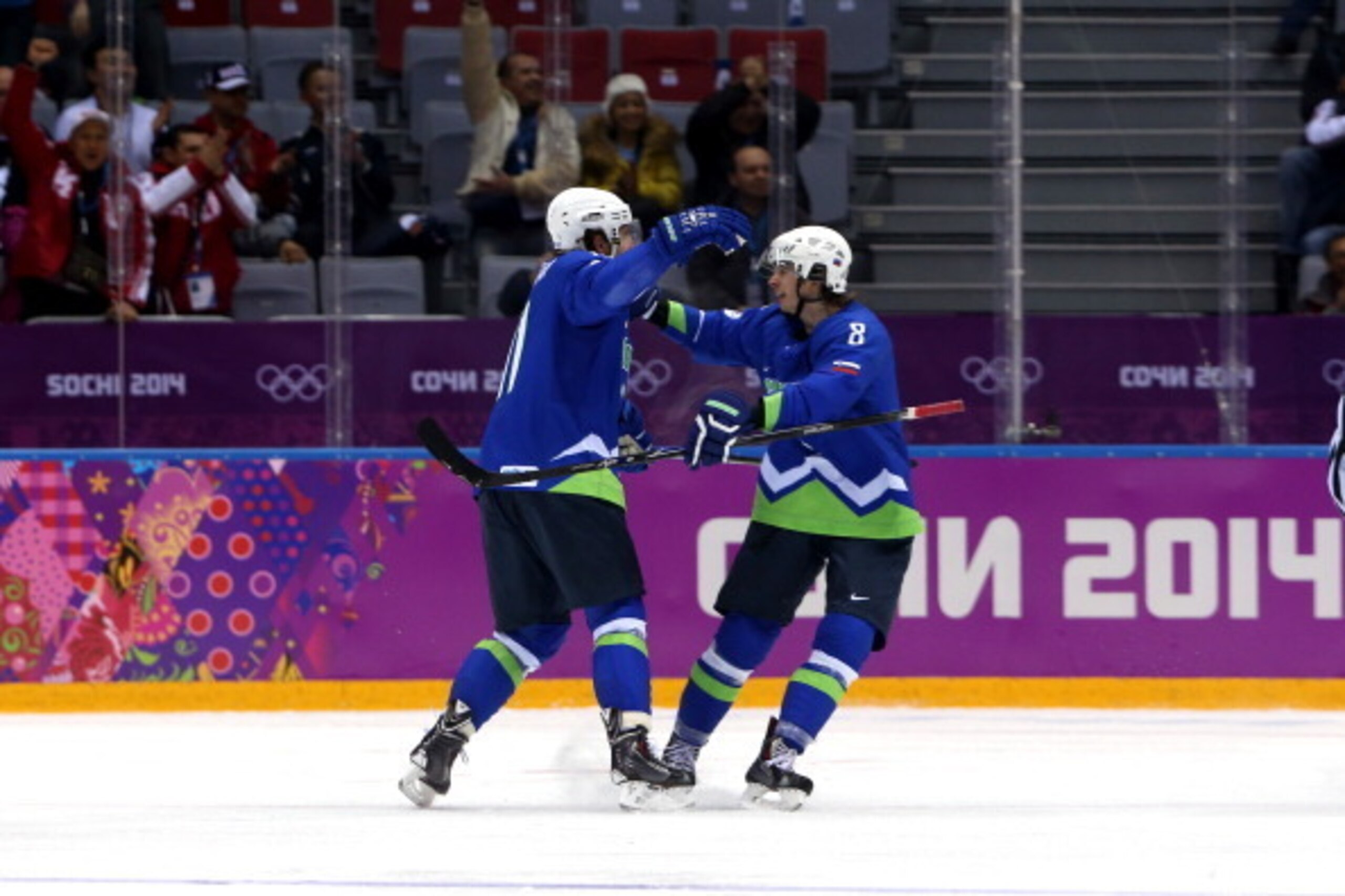 SOCHI, RUSSIA - FEBRUARY 18:  Anze Kopitar #11 of Slovenia celebrates with teammate Ziga Jeglic #8 after scoring a goal in the first period against Mathias Lange #24 of Austria during the Men's Ice Hockey Qualification Playoff game on day eleven of the So