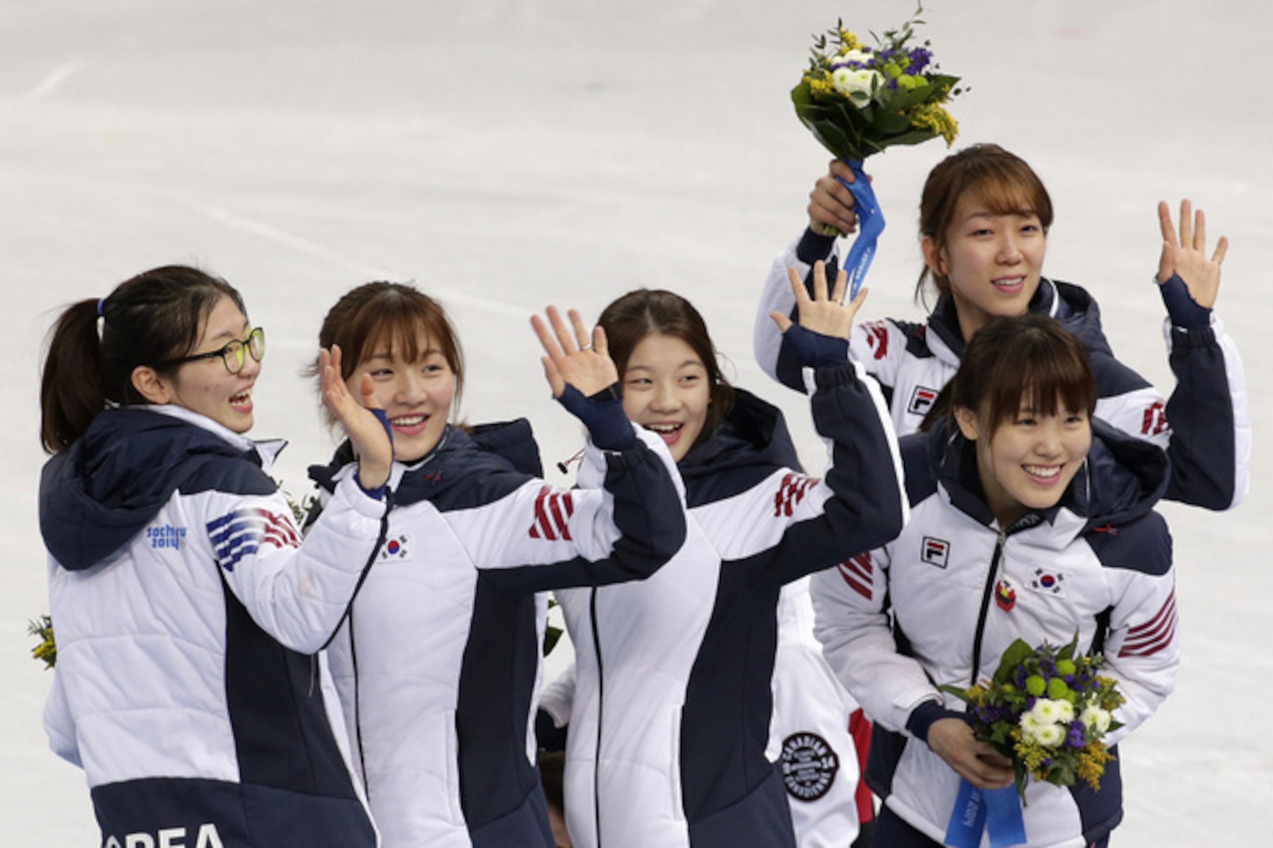 The South Korean team in jubilant mood following the flower ceremony.