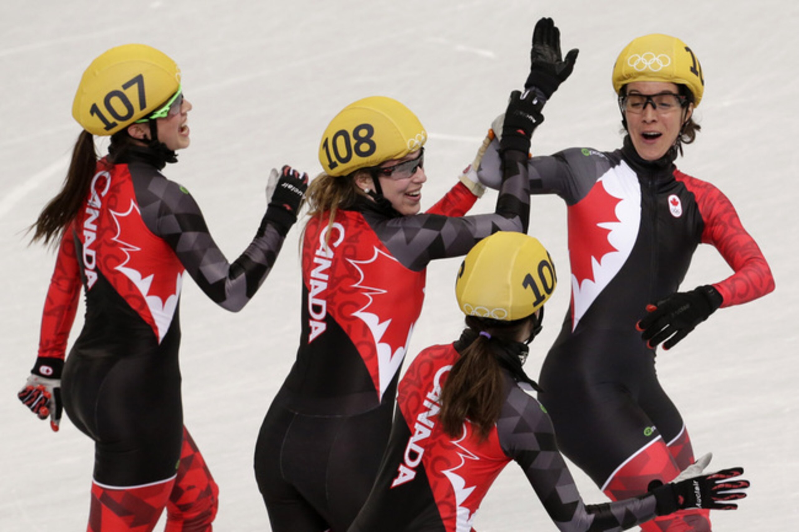 The Canadian short-track speedskating team celebrate their silver medal.