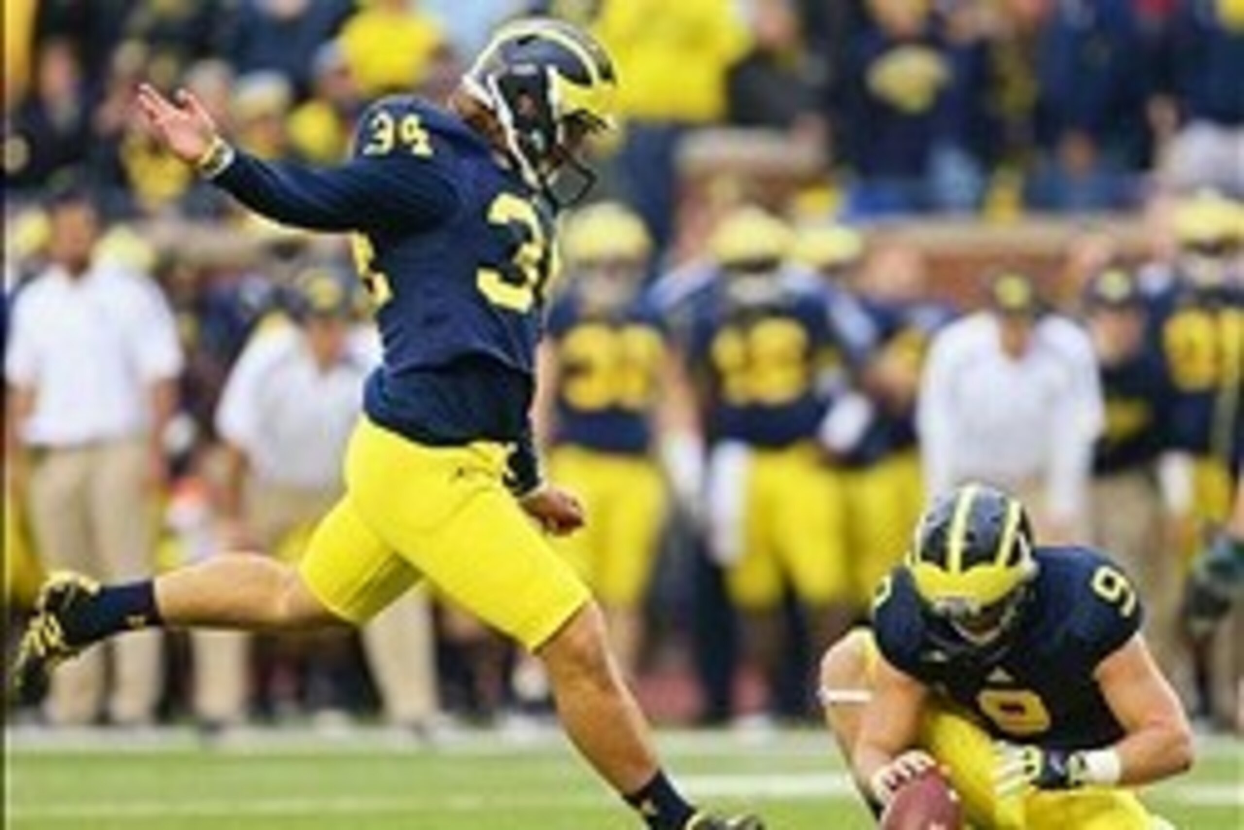 October 20, 2012; Ann Arbor, MI, USA; Michigan Wolverines kicker Brendan Gibbons (34) attempts a field goal during the second half against the Michigan State Spartans at Michigan Stadium. Michigan won 12-10.  Mandatory Credit: Mike Carter-USA TODAY Sports