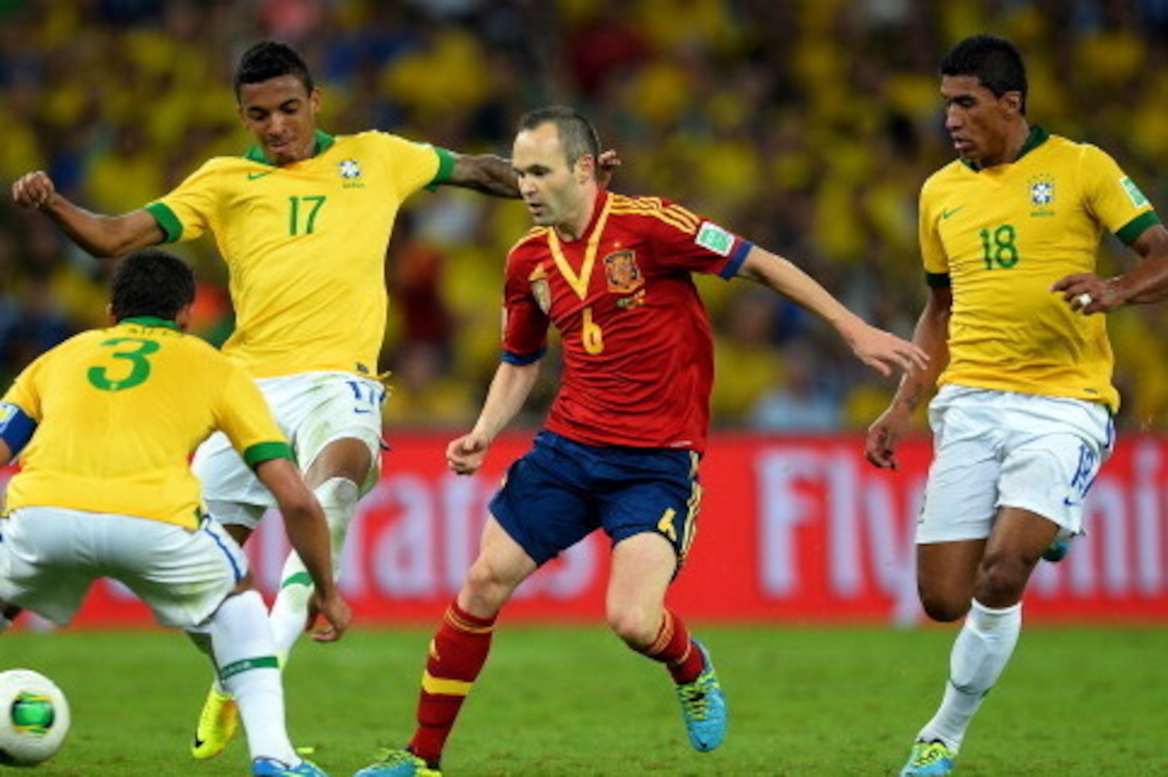 RIO DE JANEIRO, BRAZIL - JUNE 30:  Andres Iniesta of Spain competes with Thiago Silva, Luiz Gustavo and Paulinho of Brazil (R) during the FIFA Confederations Cup Brazil 2013 Final match between Brazil and Spain at Maracana on June 30, 2013 in Rio de Janei