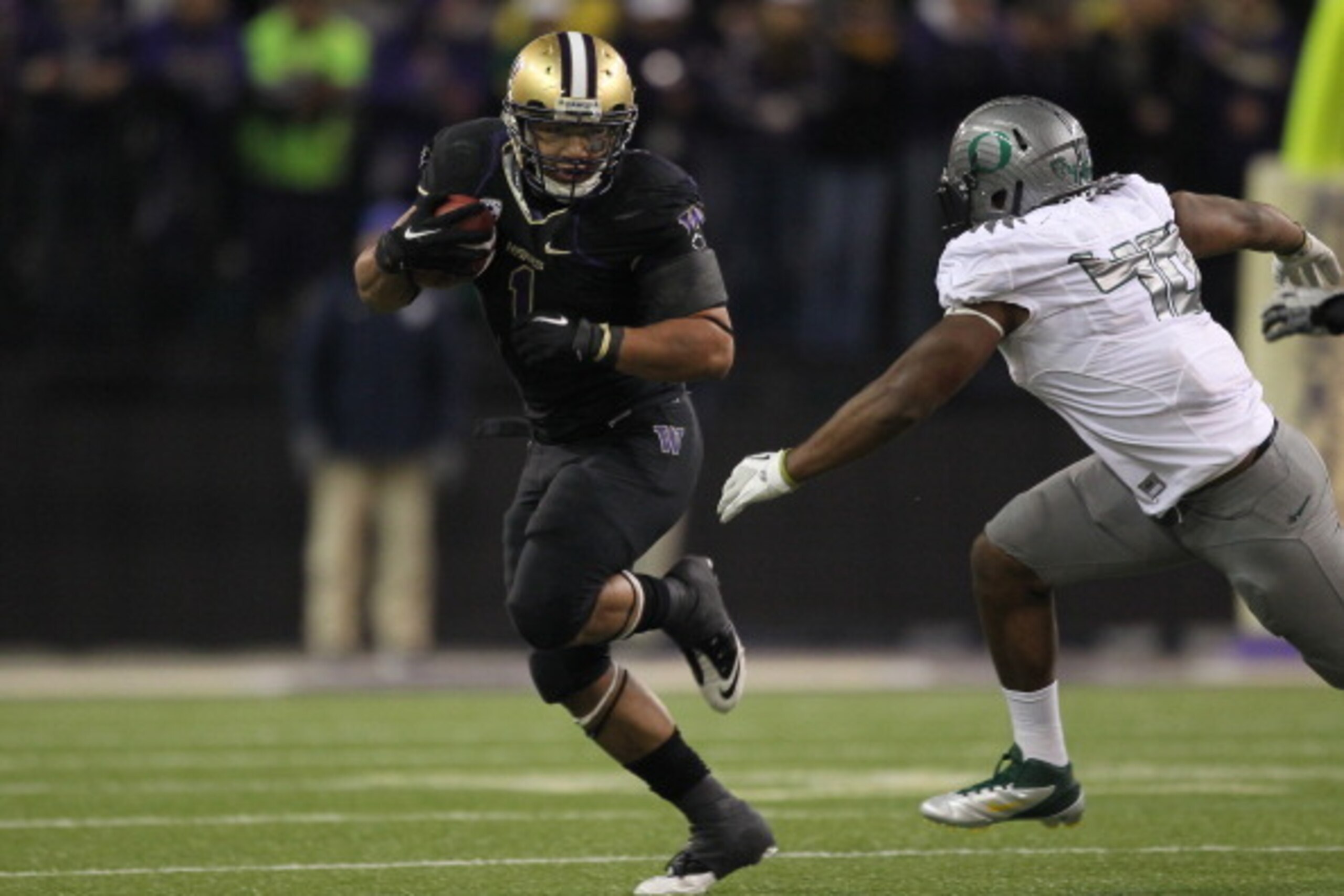 SEATTLE - NOVEMBER 05: Running back Chris Polk #1 of the Washington Huskies rushes against Michael Clay #46 of the Oregon Ducks on November 5, 2011 at Husky Stadium in Seattle, Washington. Oregon won 34-17. (Photo by Otto Greule Jr/Getty Images) SEATTLE - NOVEMBER 05: Running back Chris Polk #1 of the Washington Huskies rushes against Michael Clay #46 of the Oregon Ducks on November 5, 2011 at Husky Stadium in Seattle, Washington. Oregon won 34-17. (Photo by Otto Greule Jr/Getty Images)
