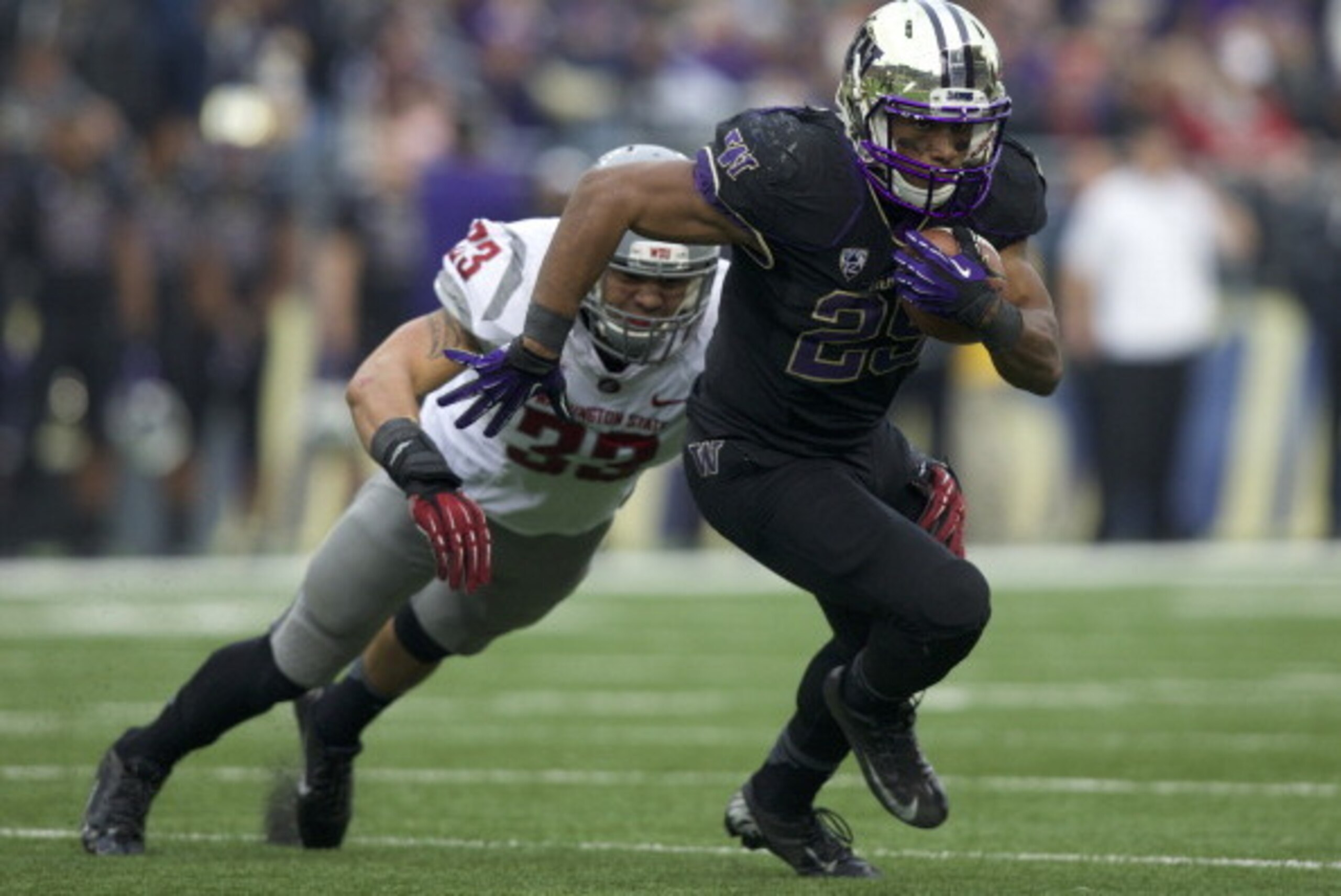 SEATTLE, WA - NOVEMBER 29: Bishop Sankey #25 of Washington rushes the ball as Tana Pritchard #33 of Washington State tries to make a tackle during the second half of a game at Husky Stadium on November 29, 2013 in Seattle, Washington. Washington won the g SEATTLE, WA - NOVEMBER 29: Bishop Sankey #25 of Washington rushes the ball as Tana Pritchard #33 of Washington State tries to make a tackle during the second half of a game at Husky Stadium on November 29, 2013 in Seattle, Washington. Washington won the g
