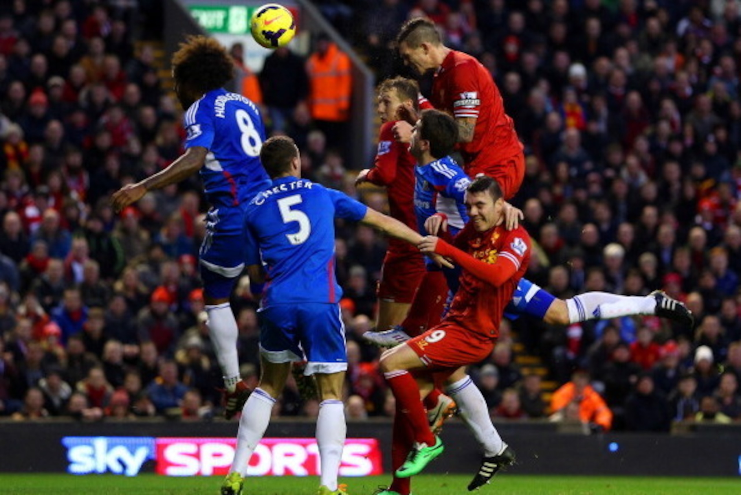 LIVERPOOL, ENGLAND - JANUARY 01:  Daniel Agger of Liverpool heads in their first goal past Tom Huddlestone of Hull City during the Barclays Premier League match between Liverpool and Hull City at Anfield on January 1, 2014 in Liverpool, England.  (Photo b