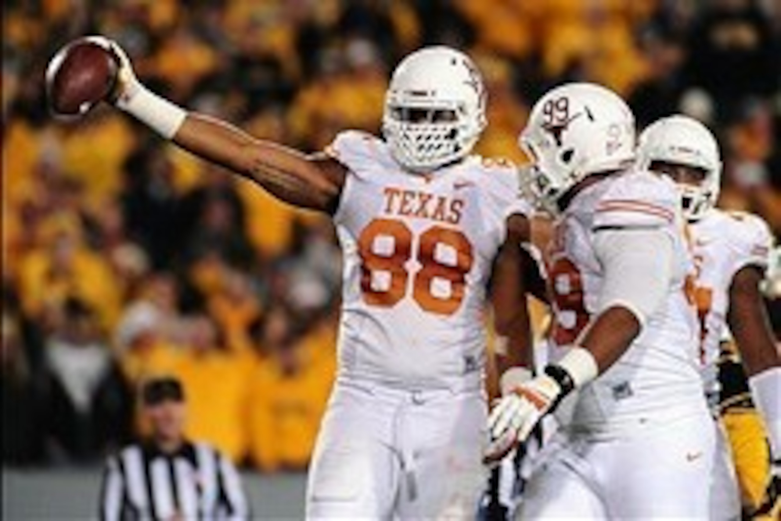 Nov 9, 2013; Morgantown, WV, USA; Texas Longhorns defensive end Cedric Reed (88) reacts after recovering a fumble in the second quarter against the West Virginia Mountaineers at Milan Puskar Stadium. Mandatory Credit: Evan Habeeb-USA TODAY Sports