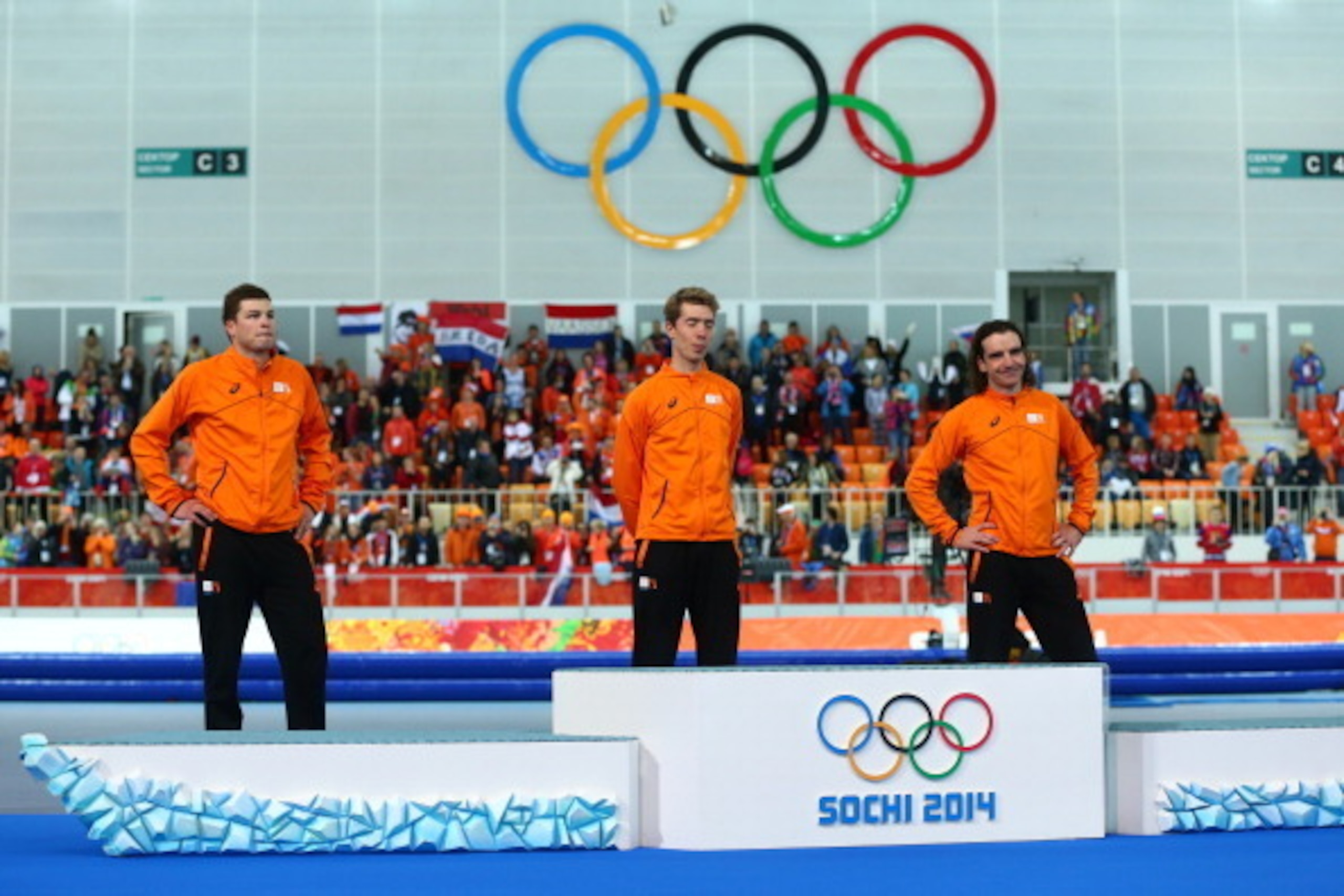 SOCHI, RUSSIA - FEBRUARY 18:  (L-R) Silver medalist Sven Kramer of the Netherlands, gold medalist Jorrit Bergsma of the Netherlands and bronze medalist Bob de Jong of the Netherlands stand infront of the podium during the flower ceremony for the Men's 100