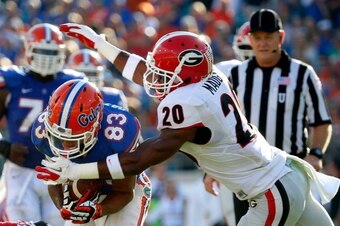 JACKSONVILLE, FL - NOVEMBER 02: Quincy Mauger #20 of the Georgia Bulldogs attempts to tackle Solomon Patton #83 of the Florida Gators during the game at EverBank Field on November 2, 2013 in Jacksonville, Florida.  (Photo by Sam Greenwood/Getty Images)