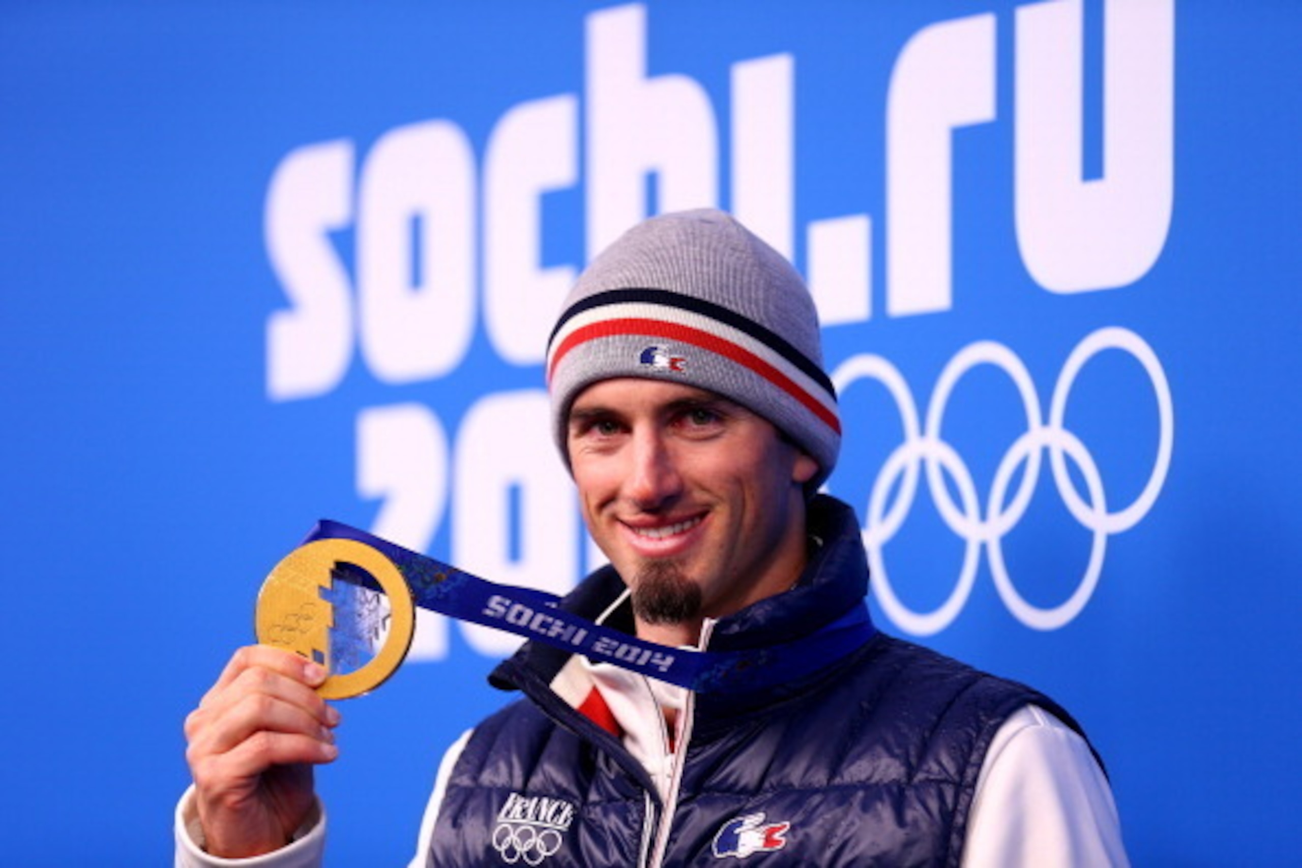 SOCHI, RUSSIA - FEBRUARY 18:  Gold medalist Pierre Vaultier of France celebrates during the medal ceremony for the Men's Snowboard Cross on day 11 of the Sochi 2014 Winter Olympics at Medals Plaza on February 18, 2014 in Sochi, Russia.  (Photo by Paul Gil