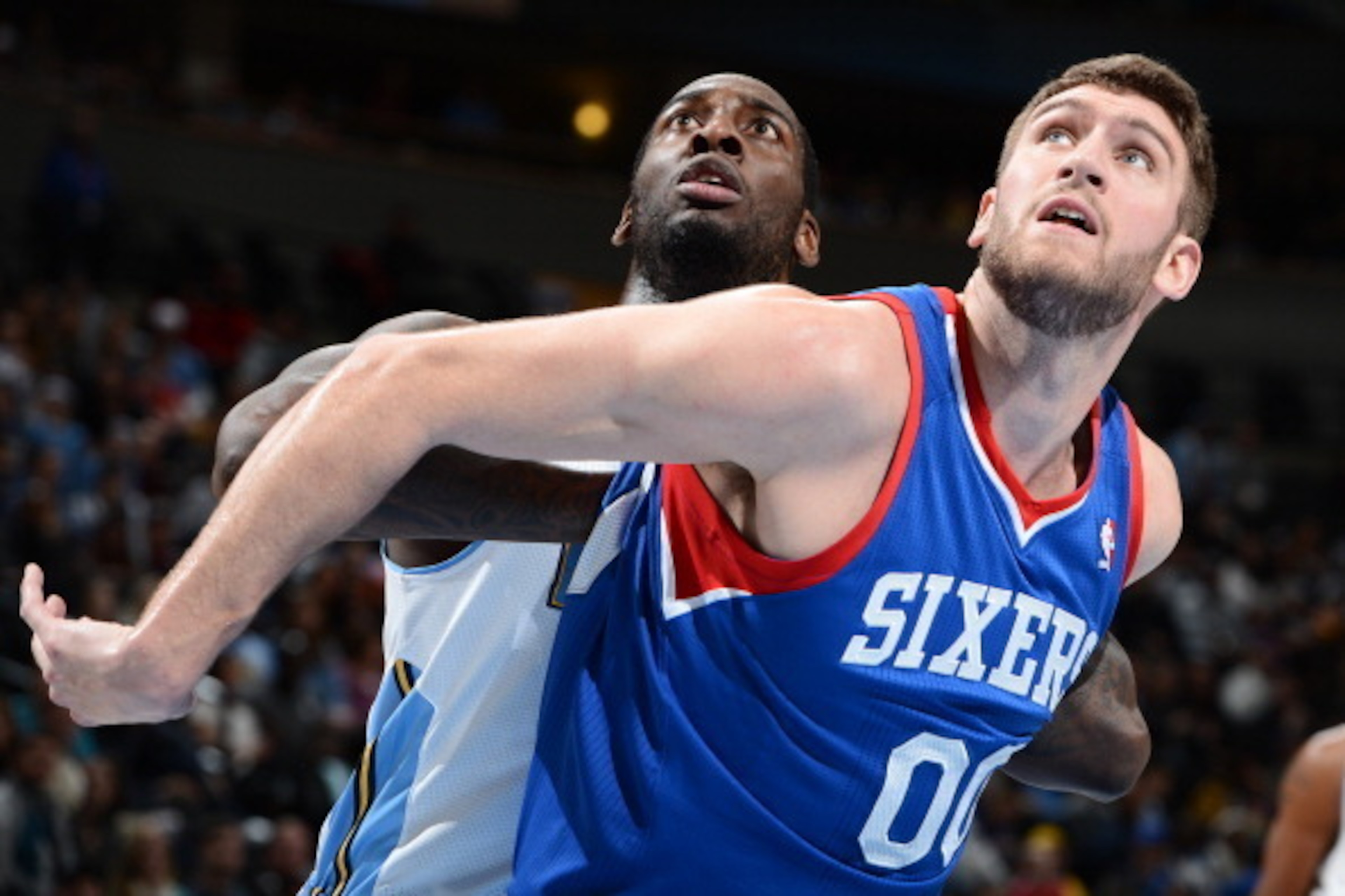 DENVER, CO - JANUARY 1: Spencer Hawes #00 of the Philadelphia 76ers boxes out J.J. Hickson #7 of the Denver Nuggets during the game on January 1, 2014 at the Pepsi Center in Denver, Colorado. NOTE TO USER: User expressly acknowledges and agrees that, by d