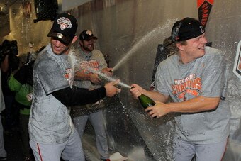 ARLINGTON, TX - NOVEMBER 01:  (L-R) Madison Bumgarner #40 and Matt Cain #18 of the San Francisco Giants celebrate in the locker room after the Giants won 3-1 against the Texas Rangers in Game Five of the 2010 MLB World Series at Rangers Ballpark in Arling