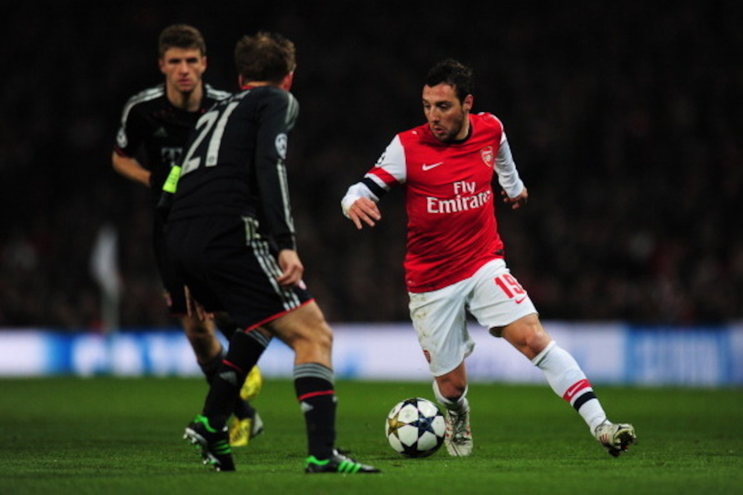 LONDON, ENGLAND - FEBRUARY 19: Santi Cazorla of Arsenal in action against Philipp Lahm of Bayern Muenchen during the UEFA Champions League round of 16 first leg match between Arsenal and Bayern Muenchen at Emirates Stadium on February 19, 2013 in London, LONDON, ENGLAND - FEBRUARY 19: Santi Cazorla of Arsenal in action against Philipp Lahm of Bayern Muenchen during the UEFA Champions League round of 16 first leg match between Arsenal and Bayern Muenchen at Emirates Stadium on February 19, 2013 in London,