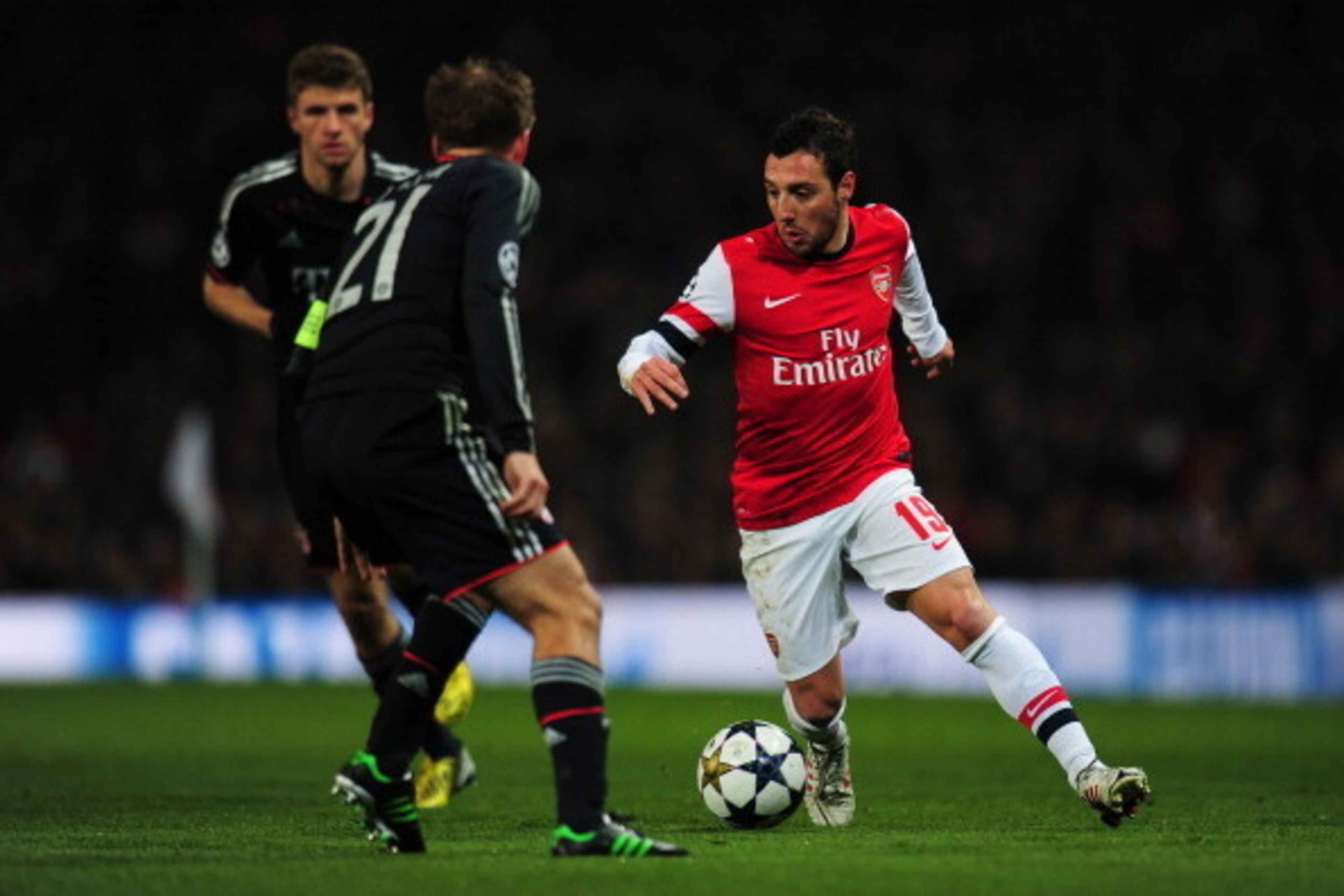 LONDON, ENGLAND - FEBRUARY 19:  Santi Cazorla of Arsenal in action against Philipp Lahm of Bayern Muenchen during the UEFA Champions League round of 16 first leg match between Arsenal and Bayern Muenchen at Emirates Stadium on February 19, 2013 in London,