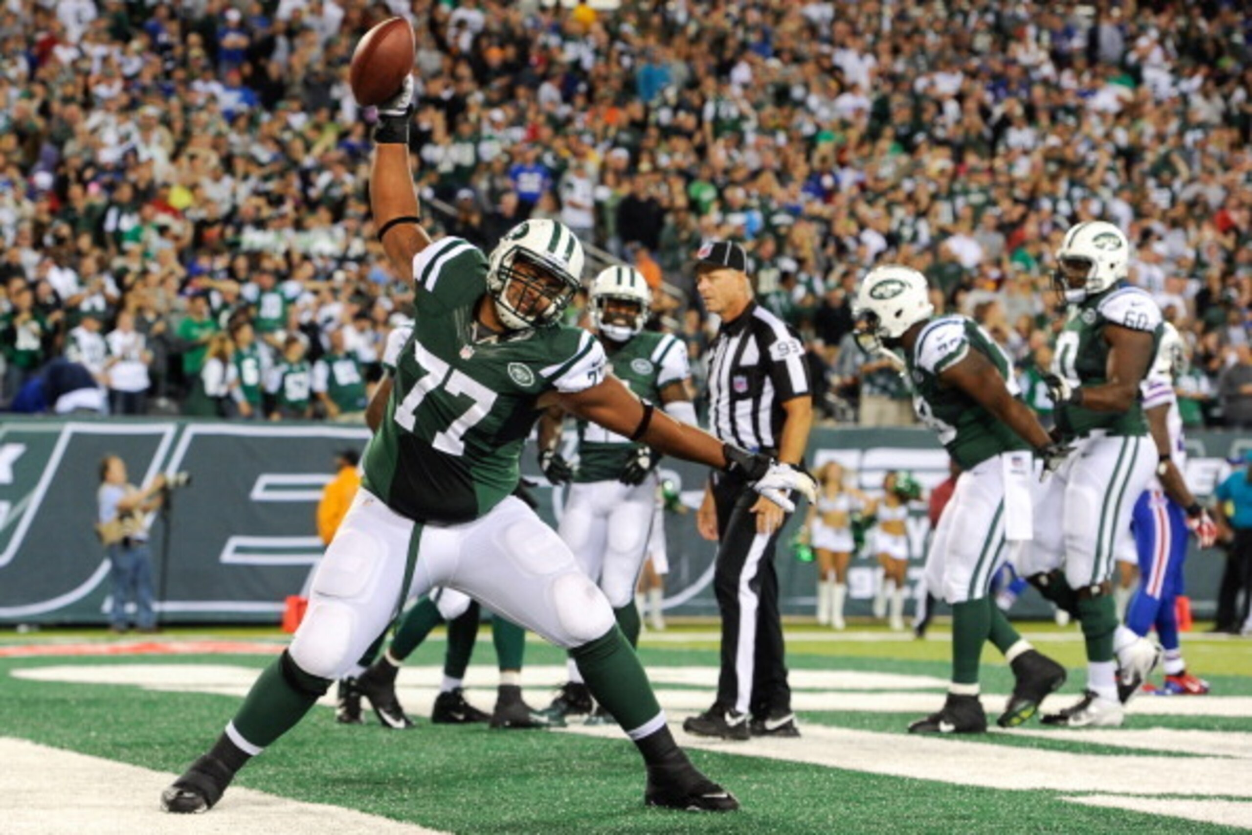 EAST RUTHERFORD, NJ - SEPTEMBER 22: Tackle Austin Howard #77 of the New York Jets spikes the ball after wide receiver Santonio Holmes #10 yard touchdown catch in the 2nd half of the Jets 27-20 win over the Buffalo Bills at MetLife Stadium on September 22,