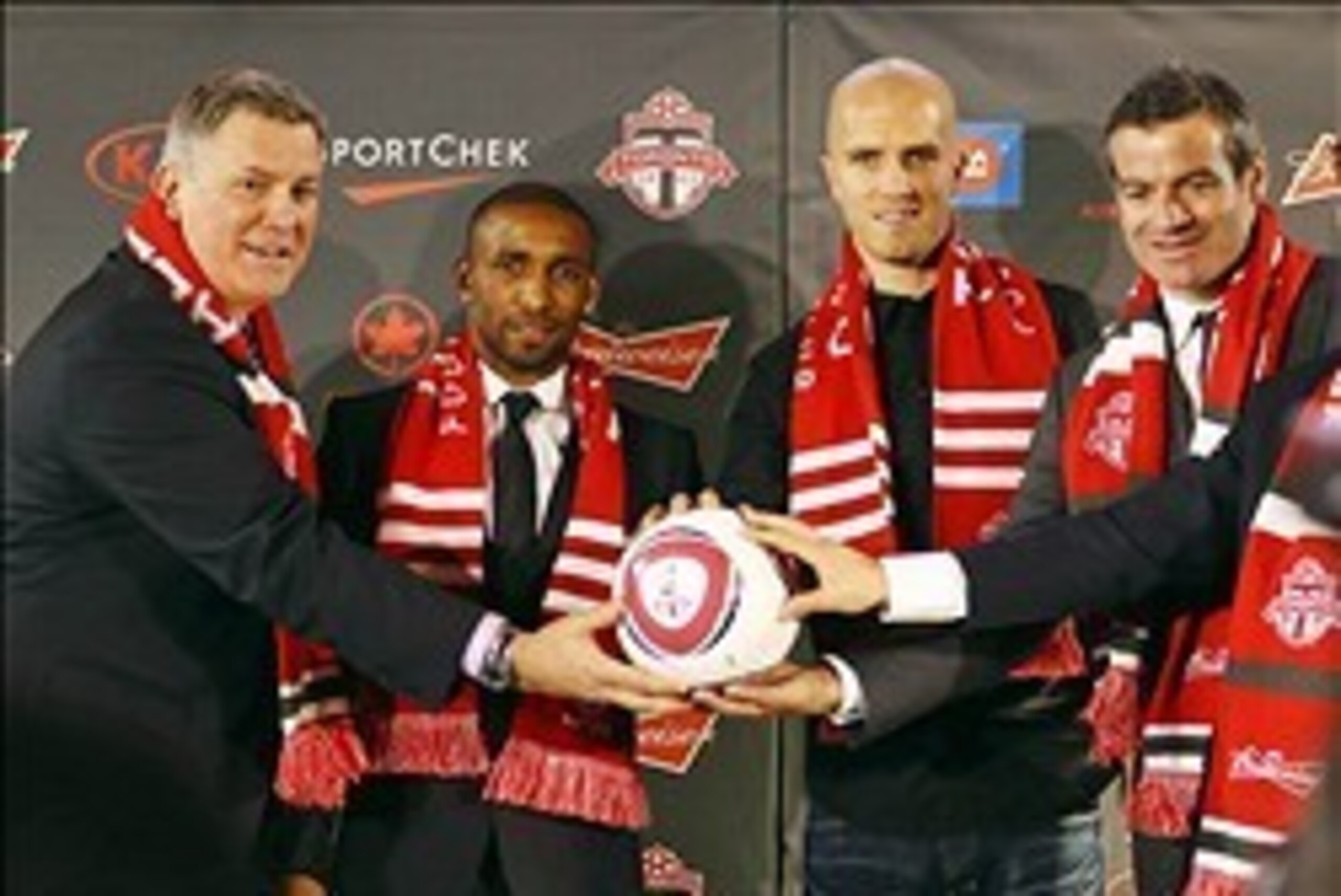 Jan 13, 2014; Toronto, Ontario, Canada; Toronto FC new players Jermain Defoe and Michael Bradley are introduced as they pose along with president and CEO of MLSE Tim Leiweke and head coach Ryan Nelsen during a press conference at Real Sports Bar and Grill