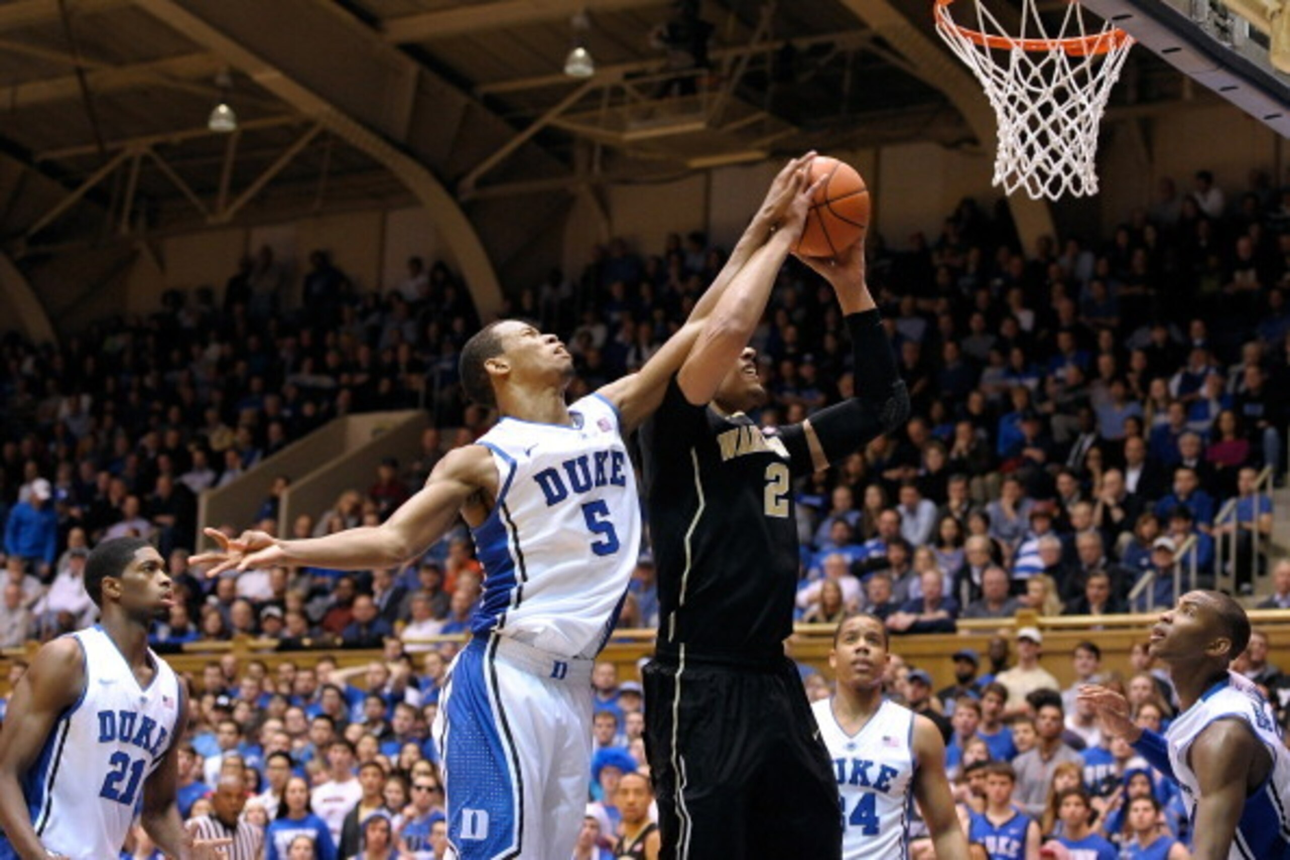 DURHAM, NC - FEBRUARY 04: Rodney Hood #5 of the Duke Blue Devils blocks a shot by Devin Thomas #2 of the Wake Forest Demon Deacons during their game at Cameron Indoor Stadium on February 4, 2014 in Durham, North Carolina. Duke won 83-63. (Photo by Grant DURHAM, NC - FEBRUARY 04: Rodney Hood #5 of the Duke Blue Devils blocks a shot by Devin Thomas #2 of the Wake Forest Demon Deacons during their game at Cameron Indoor Stadium on February 4, 2014 in Durham, North Carolina. Duke won 83-63. (Photo by Grant