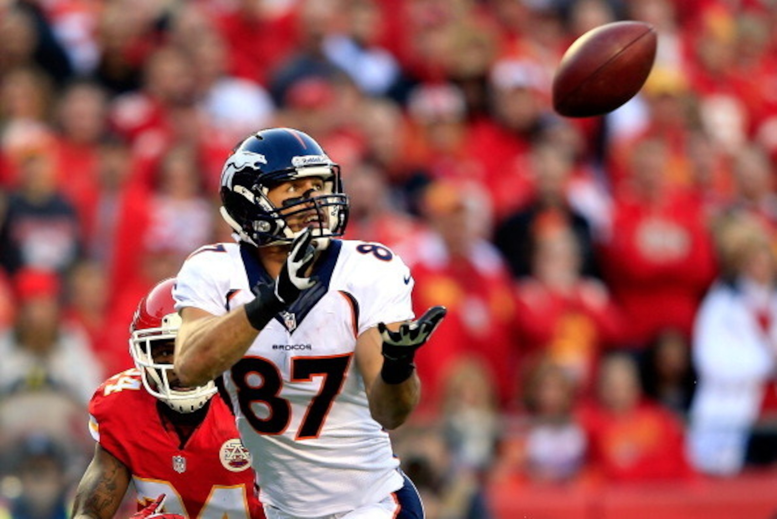 KANSAS CITY, MO - DECEMBER 01:  Wide receiver Eric Decker #87 of the Denver Broncos makes a catch in the end zone for a touchdown as cornerback Brandon Flowers #24  of the Kansas City Chiefs defends during the game at Arrowhead Stadium on December 1, 2013