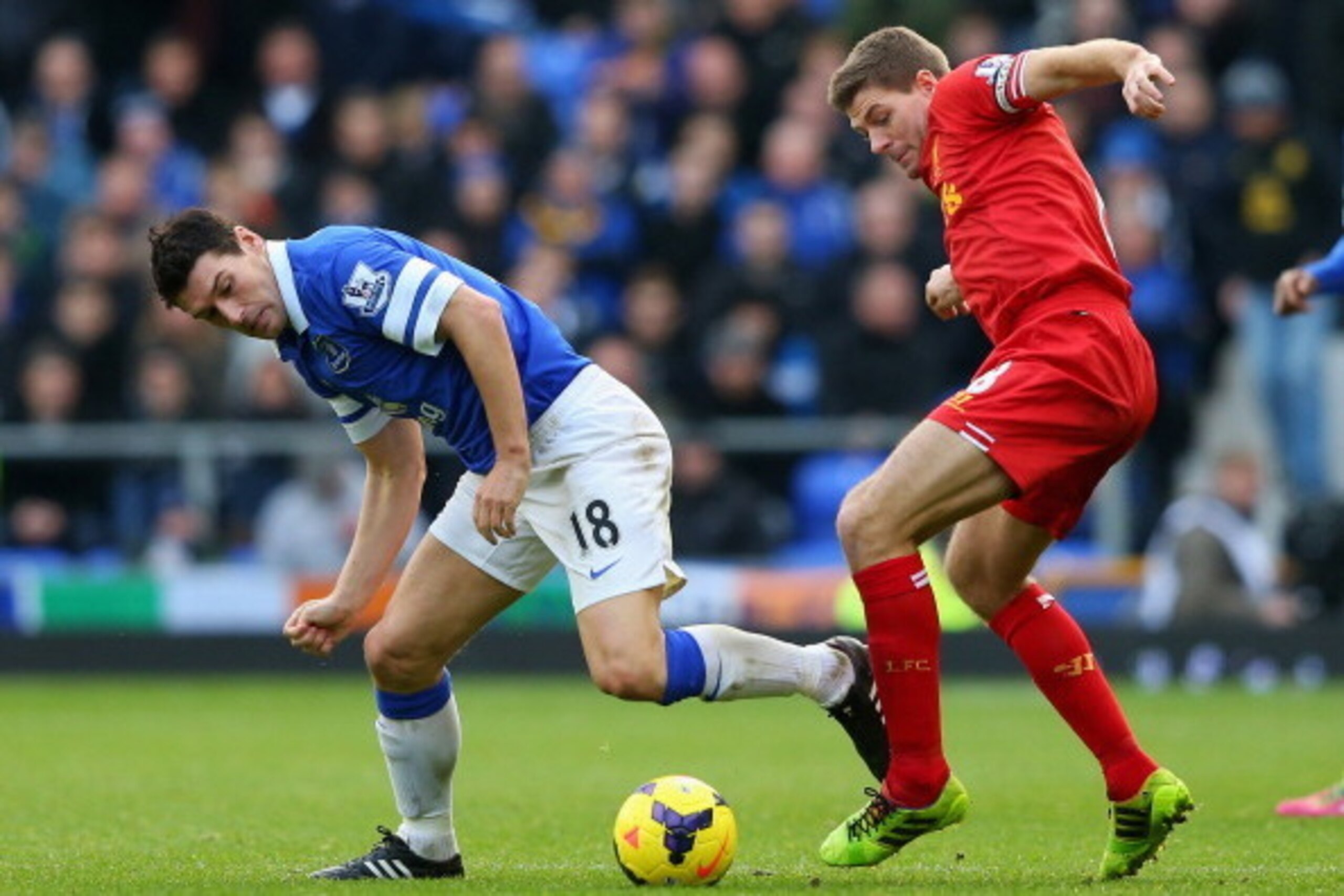 LIVERPOOL, ENGLAND - NOVEMBER 23:  Steven Gerrard of Liverpool tangles with Gareth Barry of Everton during the Barclays Premier League match between Everton and Liverpool at Goodison Park on November 23, 2013 in Liverpool, England.  (Photo by Alex Livesey